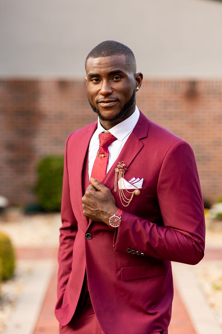 Stylish burgundy suit with red tie and orange shoes shown in multiple fashion poses.