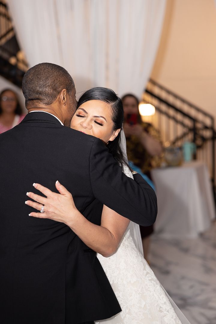 A tender first dance moment between newlyweds at their wedding reception.