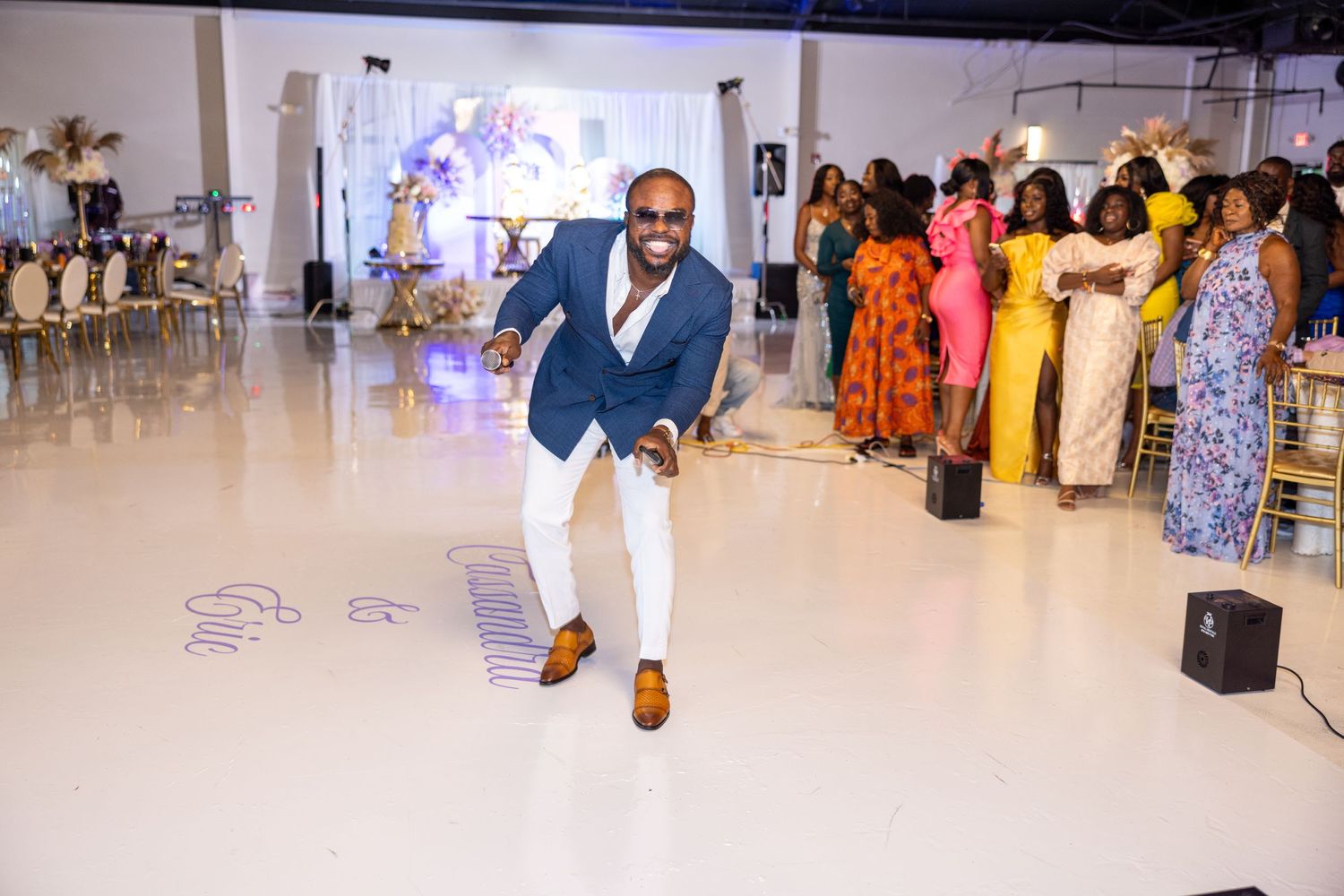 Modern wedding venue with sleek white floors and elegant party decorations.