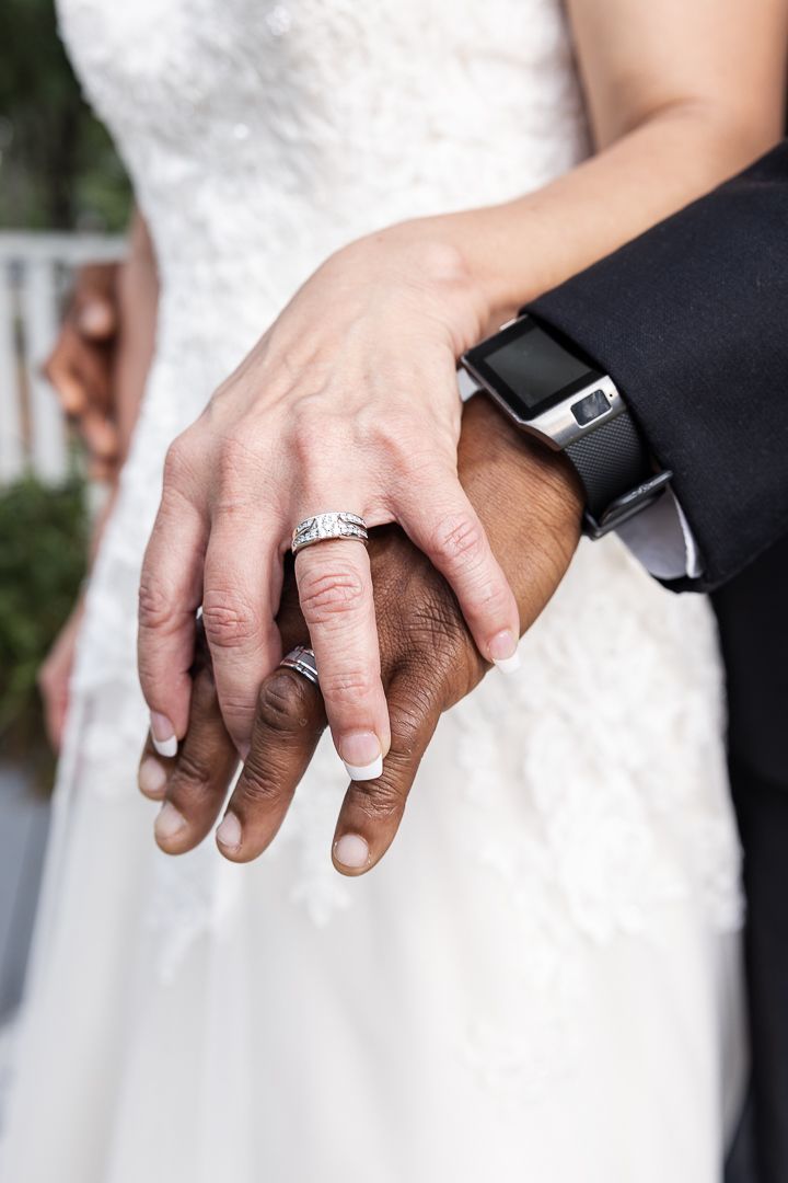 Close-up shots of newlyweds holding hands showing their wedding rings.