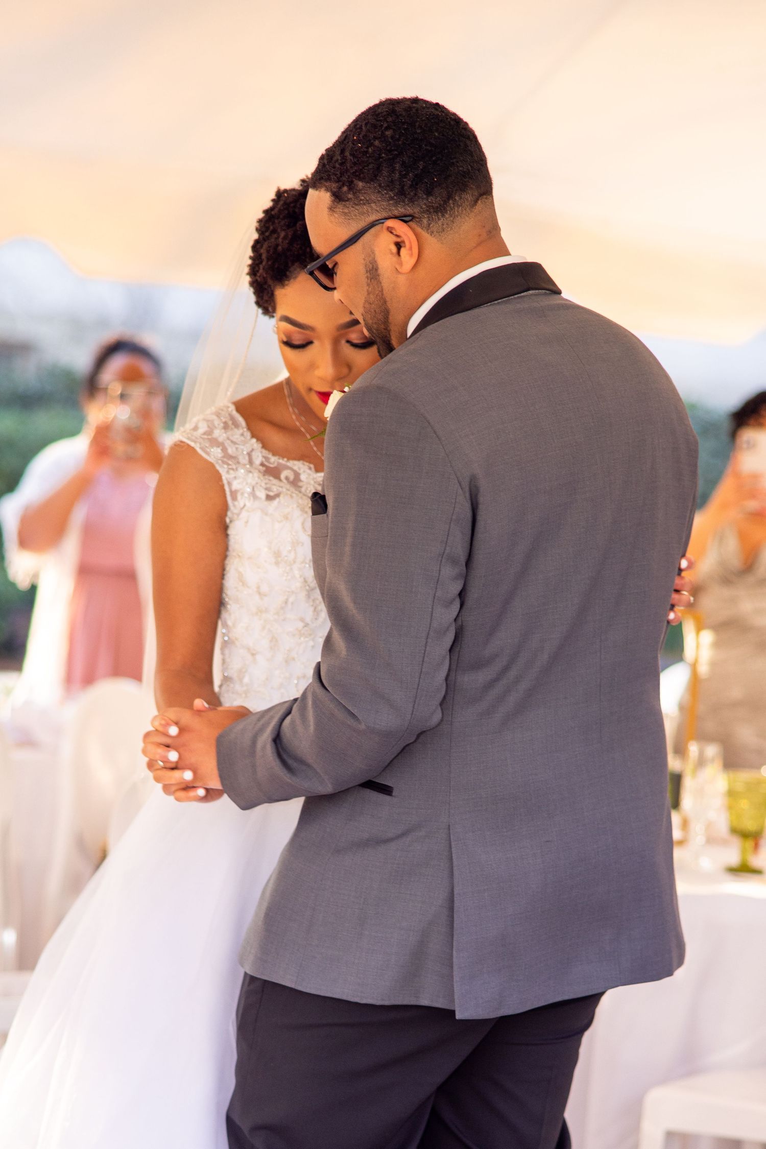 A tender wedding moment as a couple shares an intimate dance at their outdoor celebration.