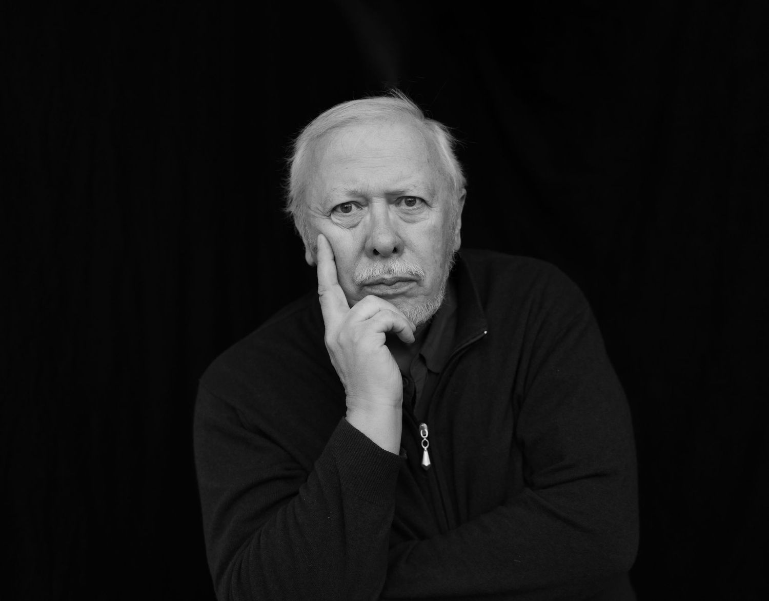 Black and white portrait series showing contemplative expressions against dark background.