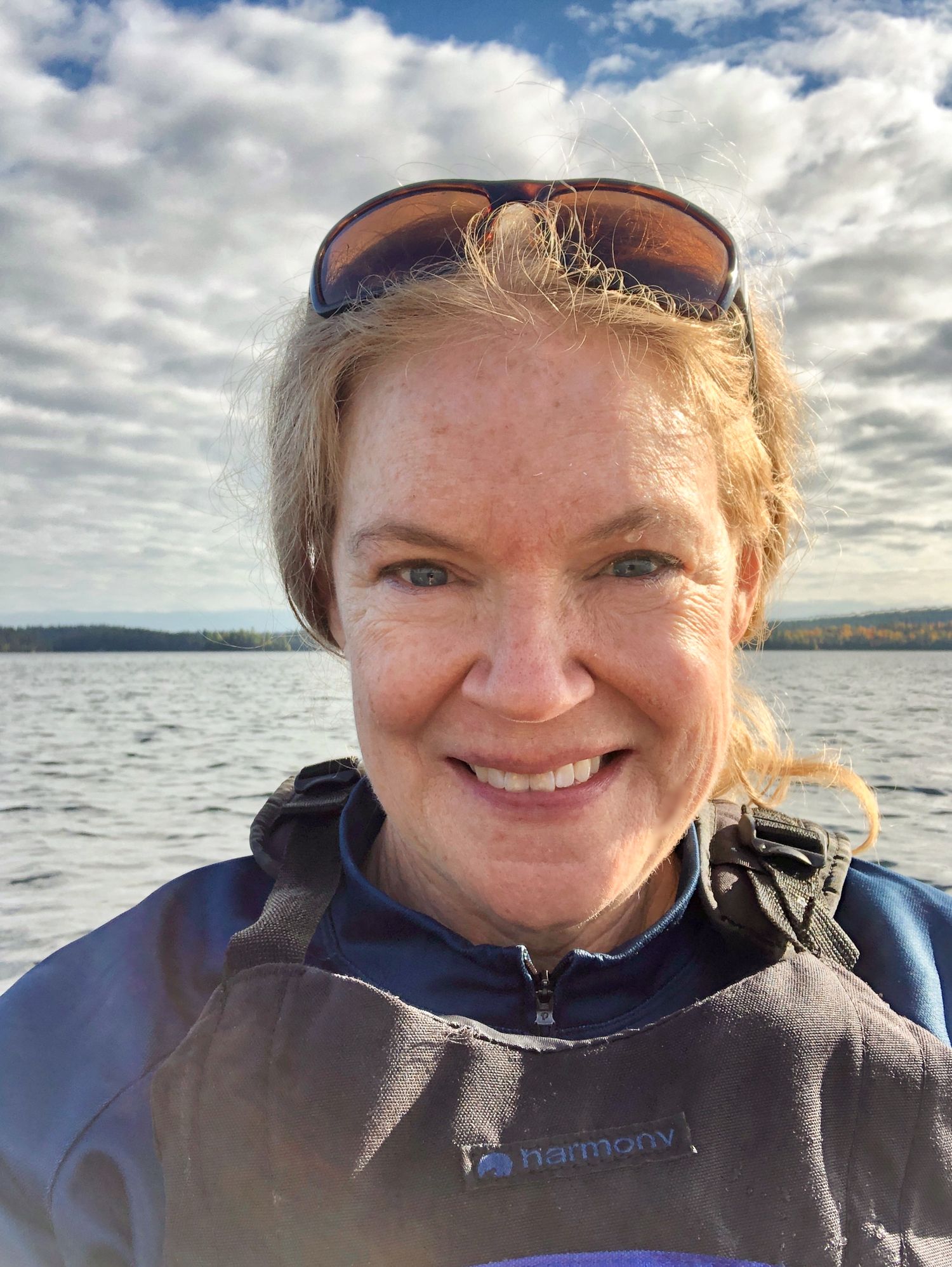 Close-up selfie shots taken on a boat with cloudy sky and water in background.