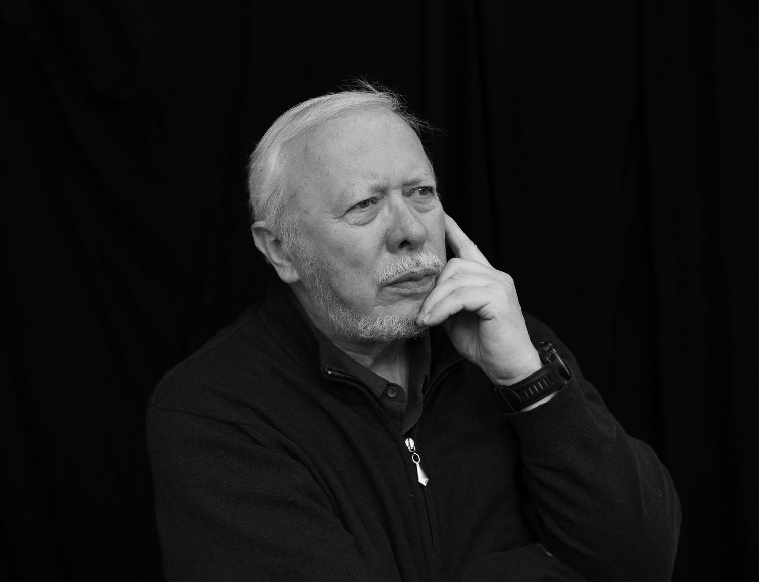 A series of black and white photos showing someone in dark clothing with contemplative expressions.