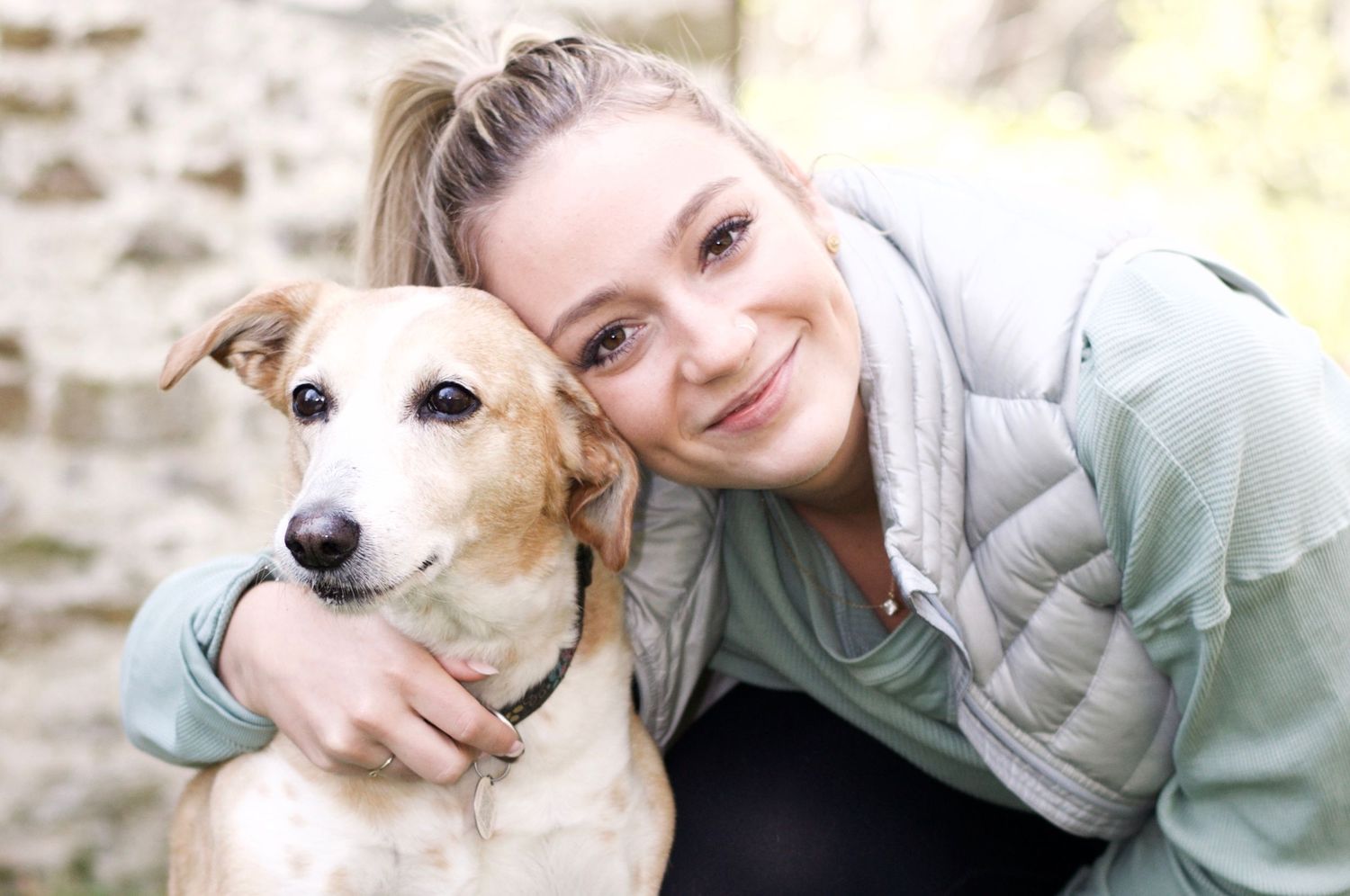 A person and their dog share an affectionate moment.
