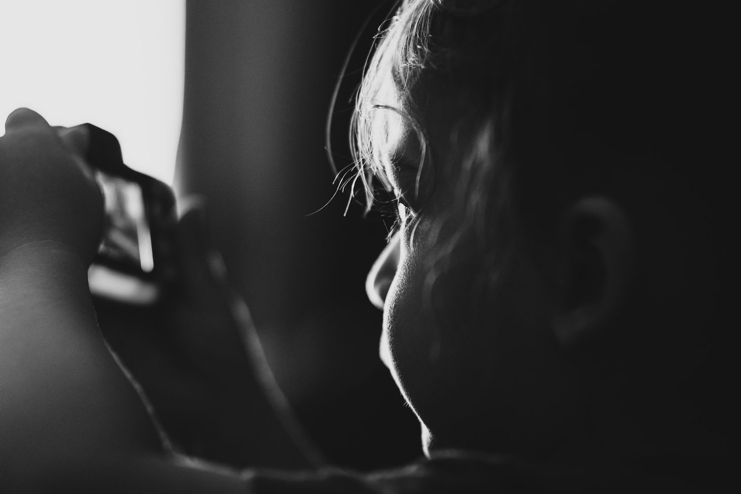 A black and white image shows the silhouette of a person's face in profile.
