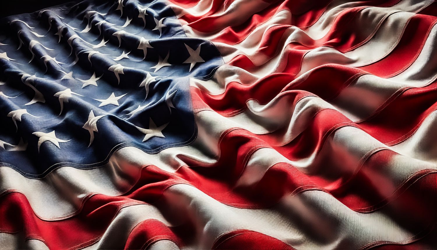 Close-up of a waving American flag with vivid red, white, and blue colors and textured fabric detail.