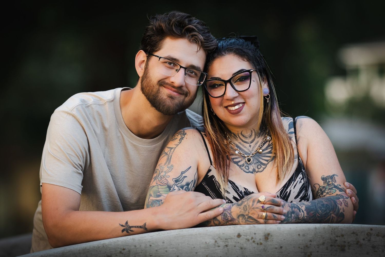 A happy couple smiling and embracing outdoors.