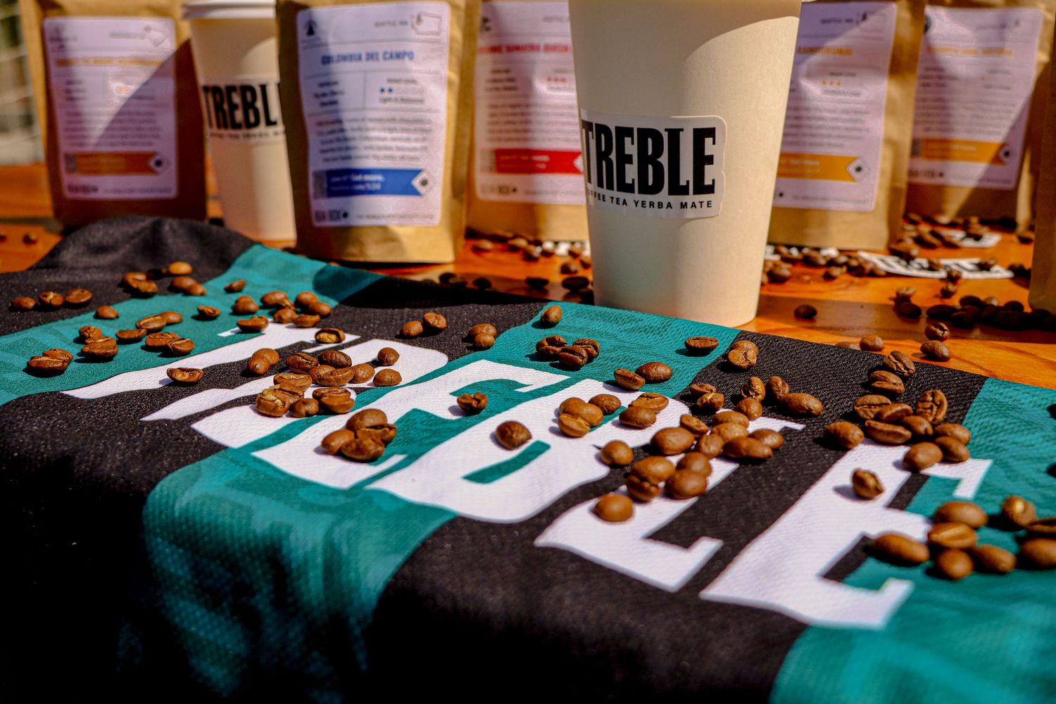 Catered food and drinks displayed on teal tablecloth with Treble branding.