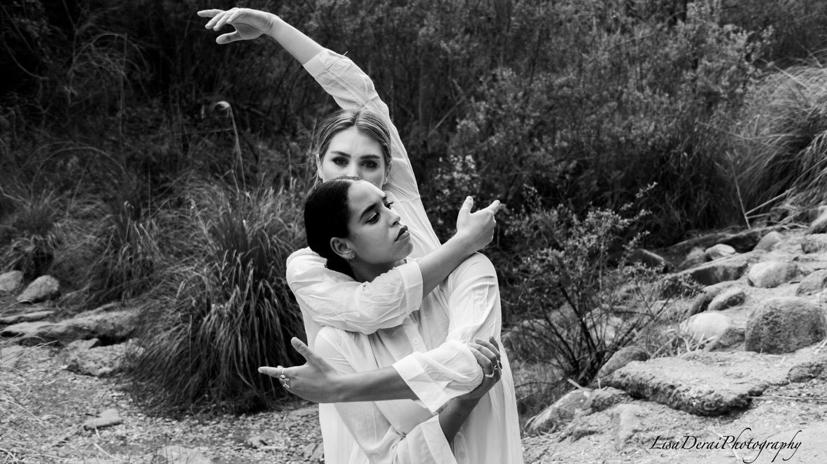 Dramatic black and white dance sequence photographed against natural outdoor backdrop.