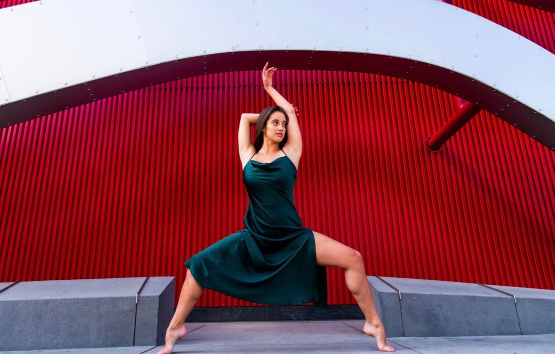 Modern dance movements photographed against geometric red and white architecture.