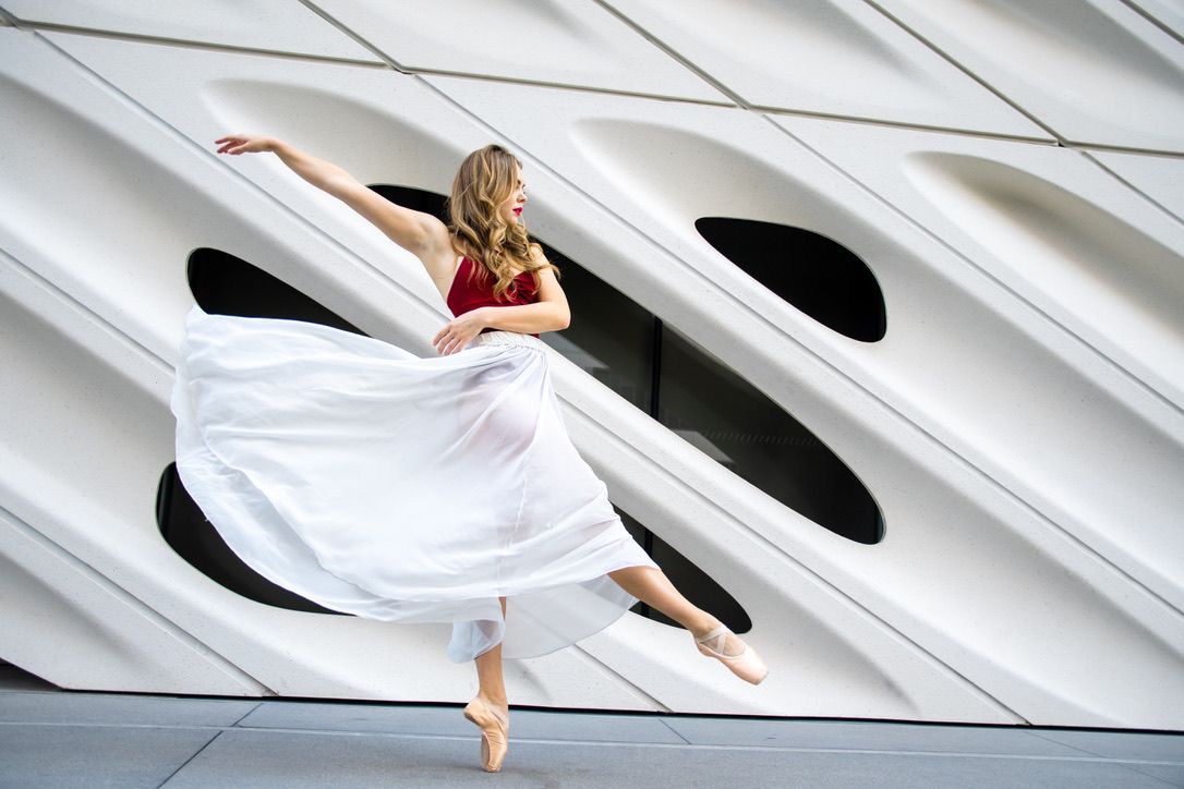 Abstract dance movements captured on white geometric architectural background.