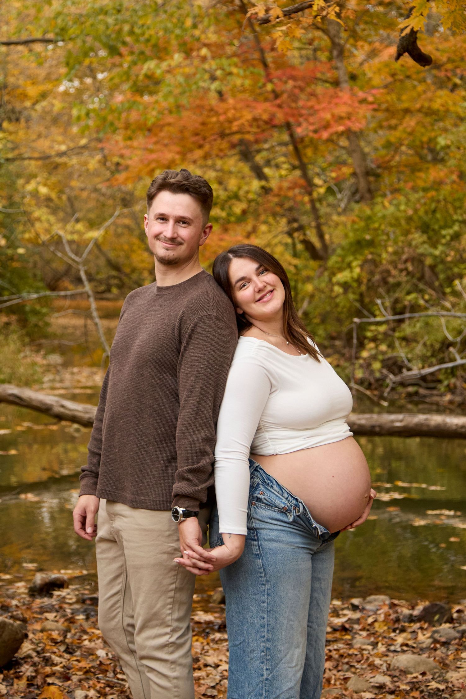 Maternity photo of mom and dad in fall setting.