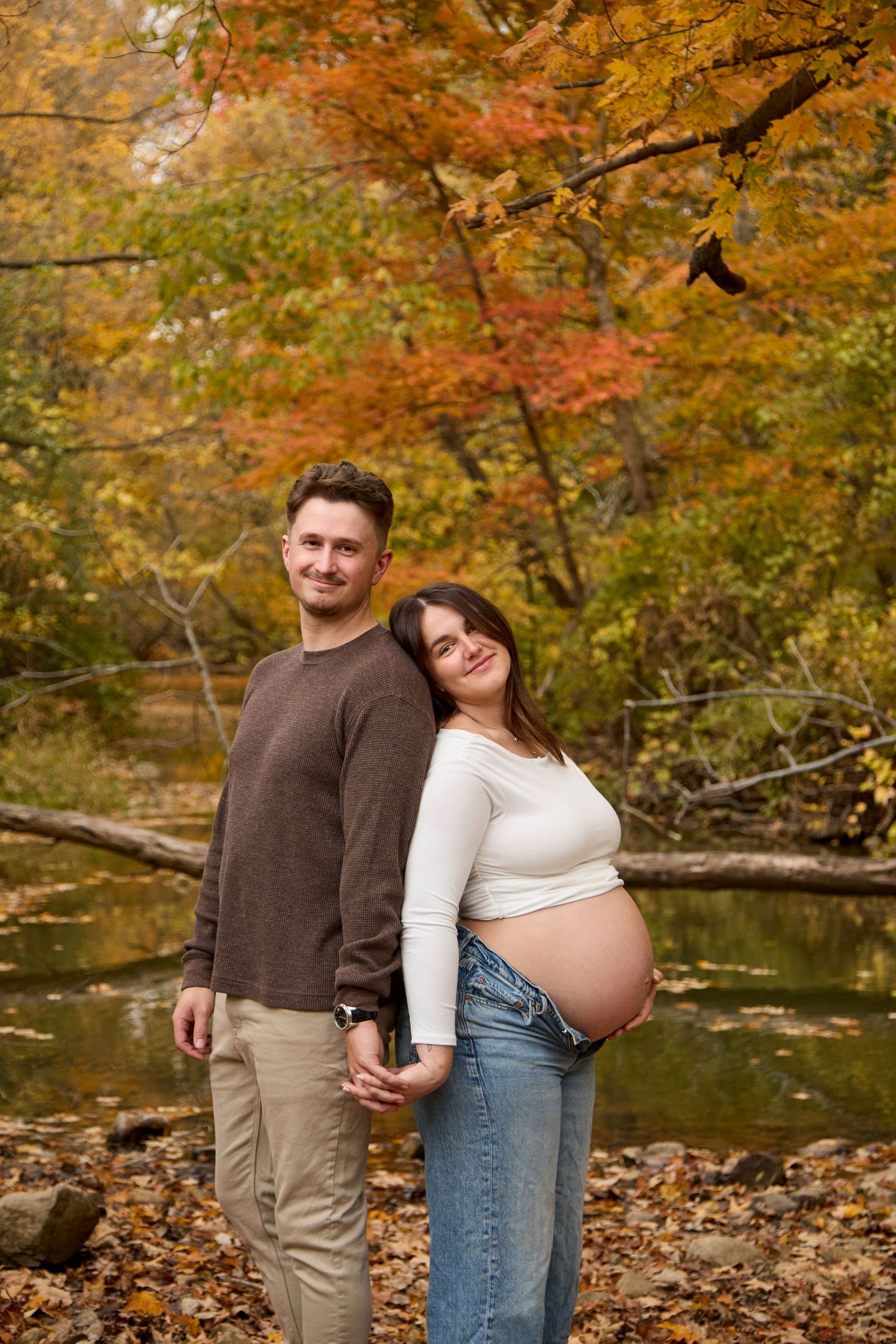 Maternity photo of mom and dad in fall setting.
