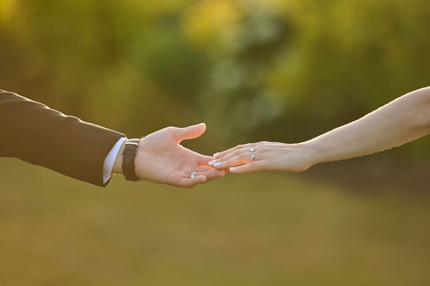 Hands touching at golden hour.