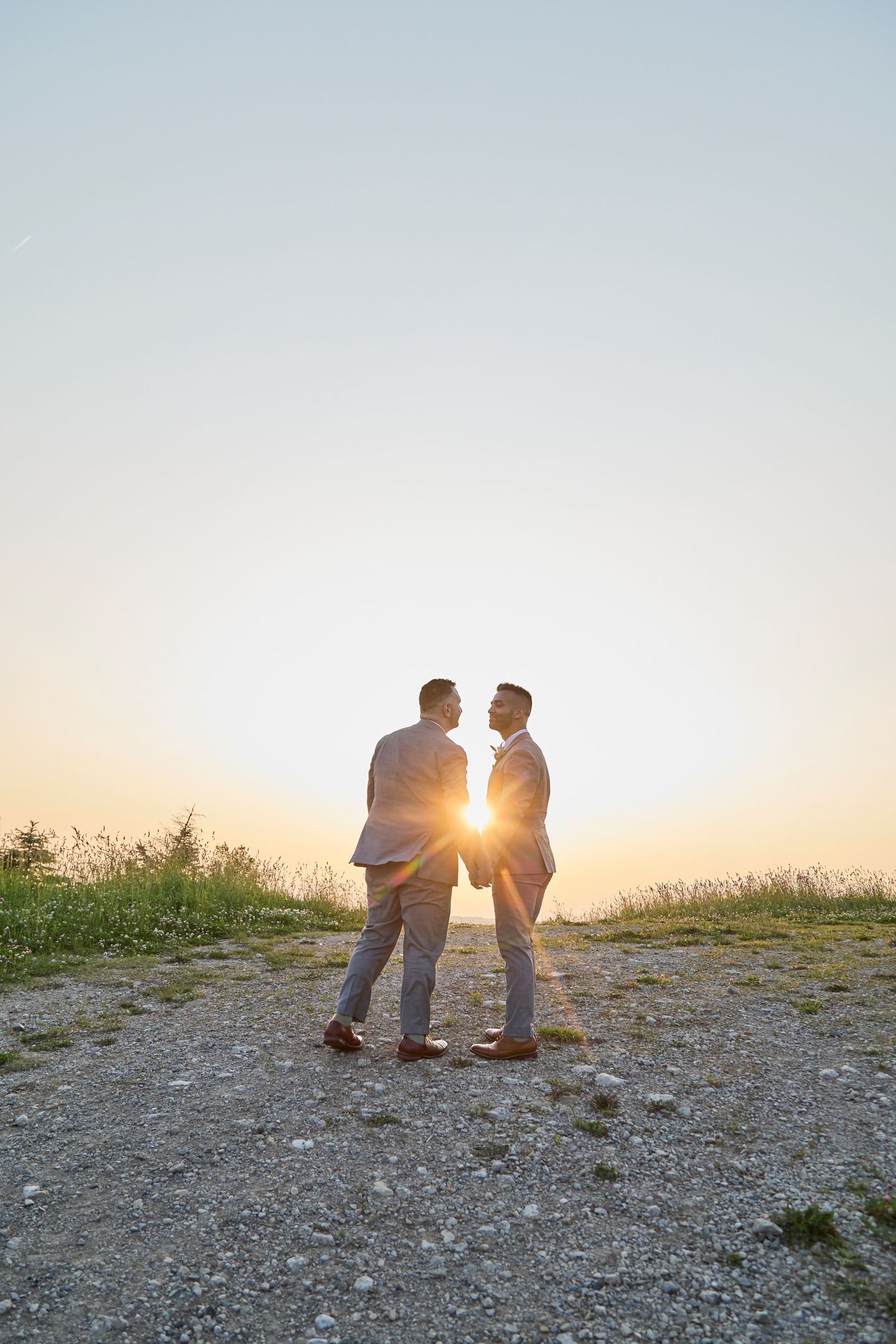Groom and groom on Boler Mountain at golden hour.