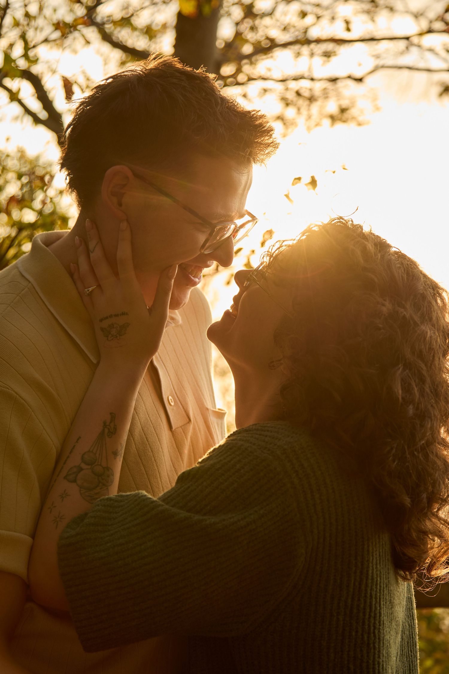 Engaged couple admiring each other at golden hour.