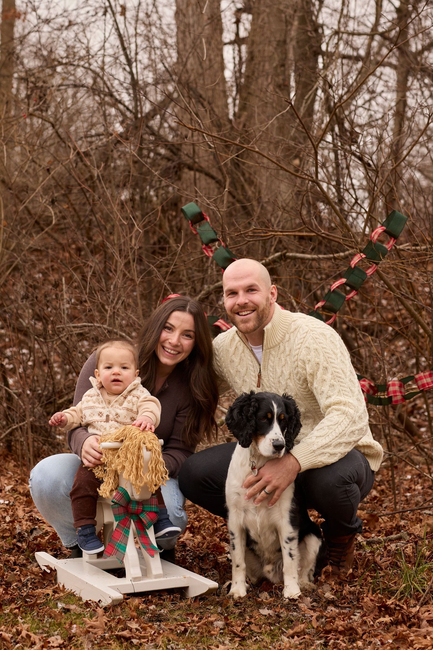 Christmas scene of family in winter setting.