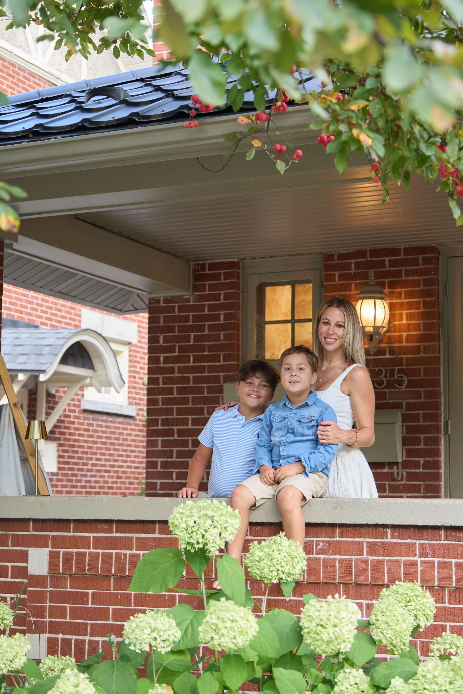Family on porch with hydrangeas.