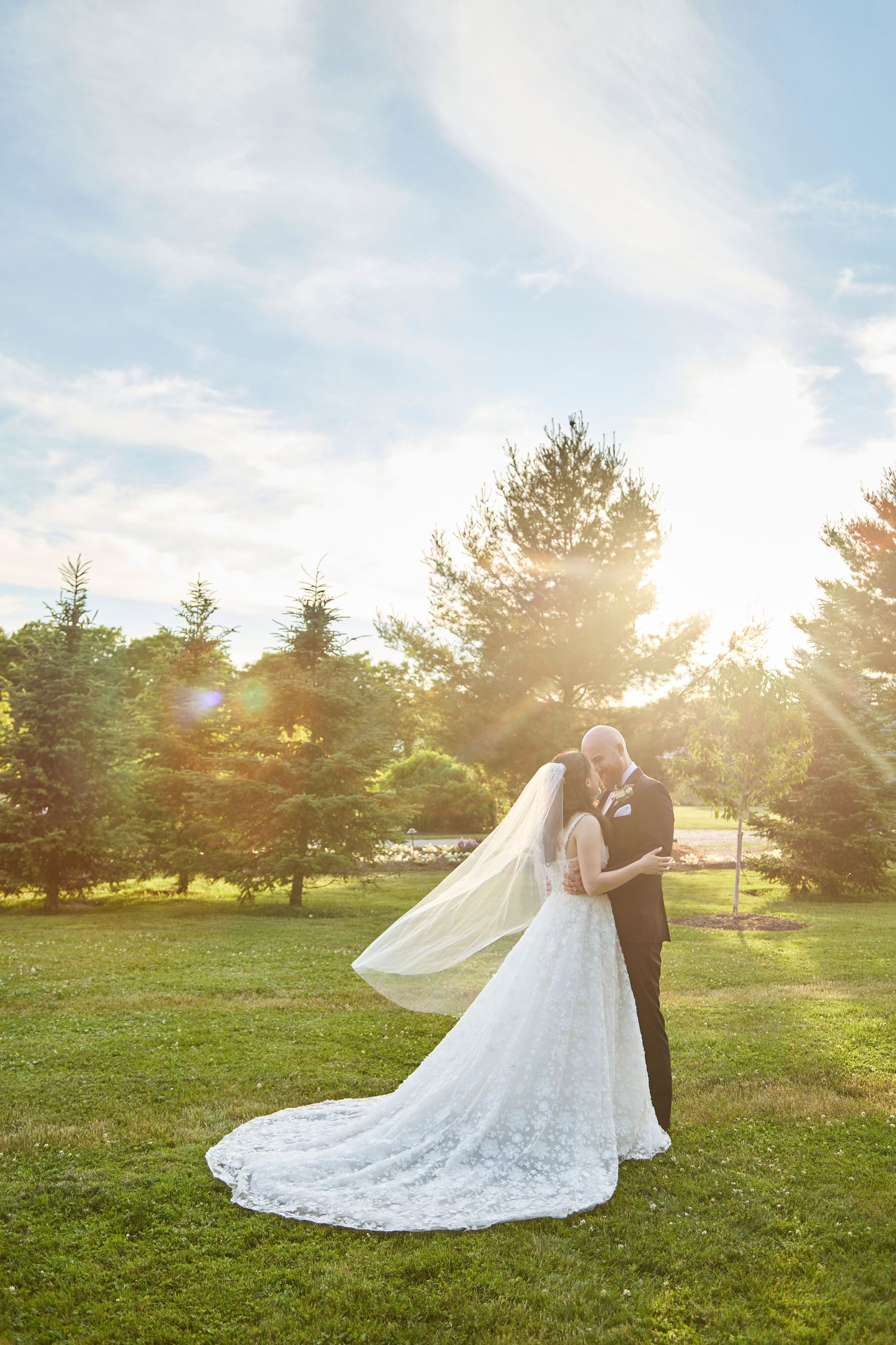 Bride and groom at golden hour with beautiful sky.