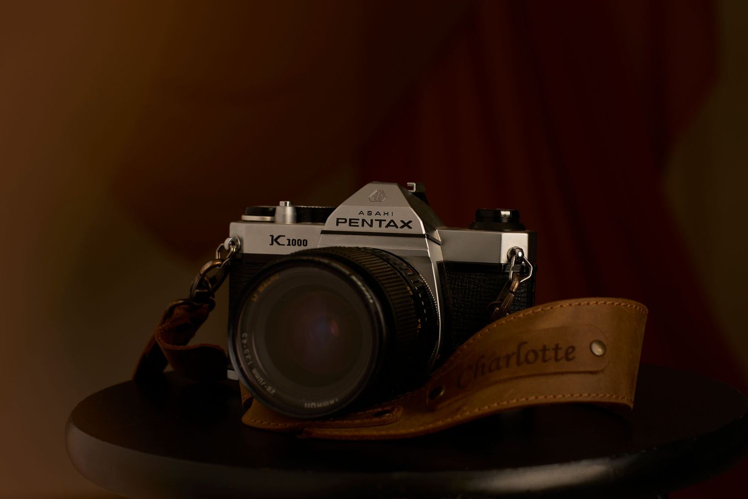 Vintage film camera with custom leather strap.