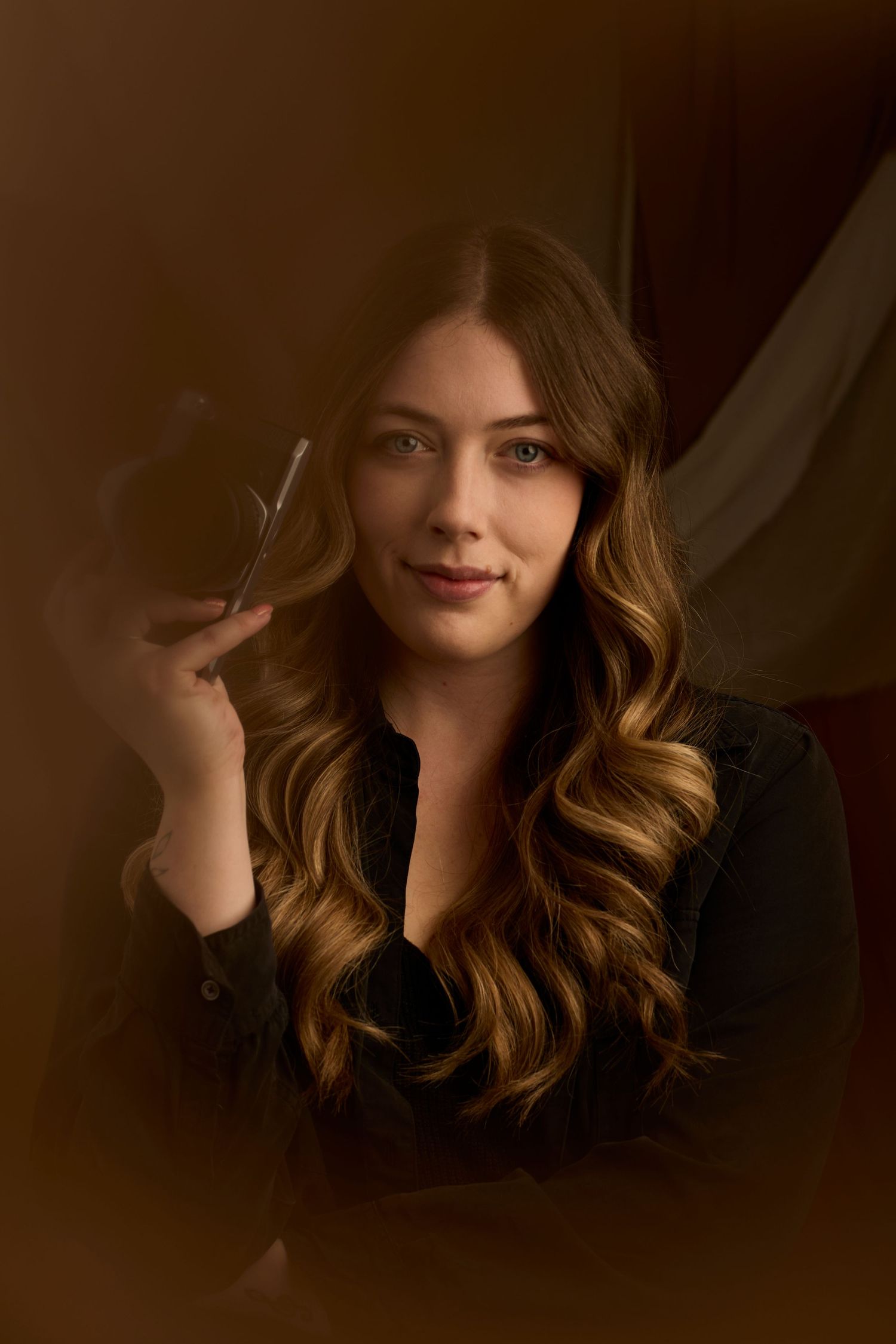 Charlotte Poolton headshot on brown background.