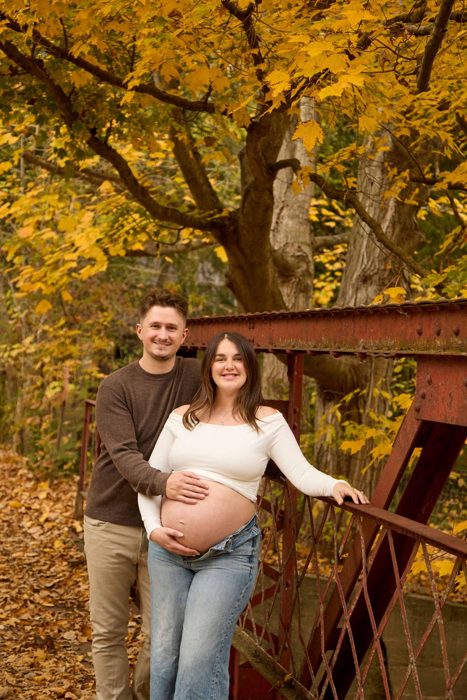 Maternity photo of mom and dad in fall setting.