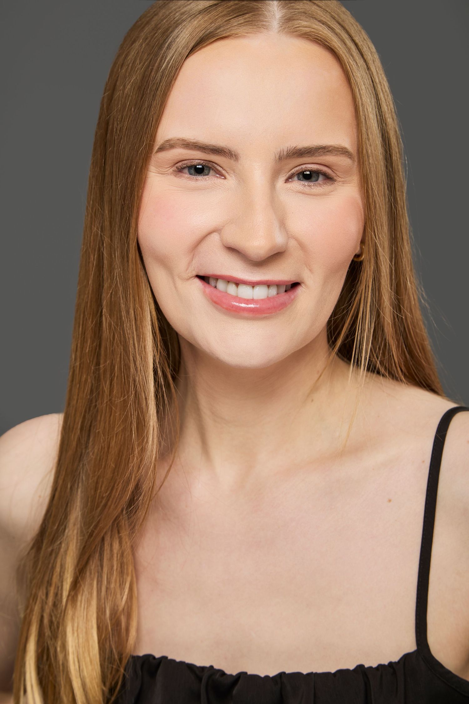 Actor headshot on grey background.