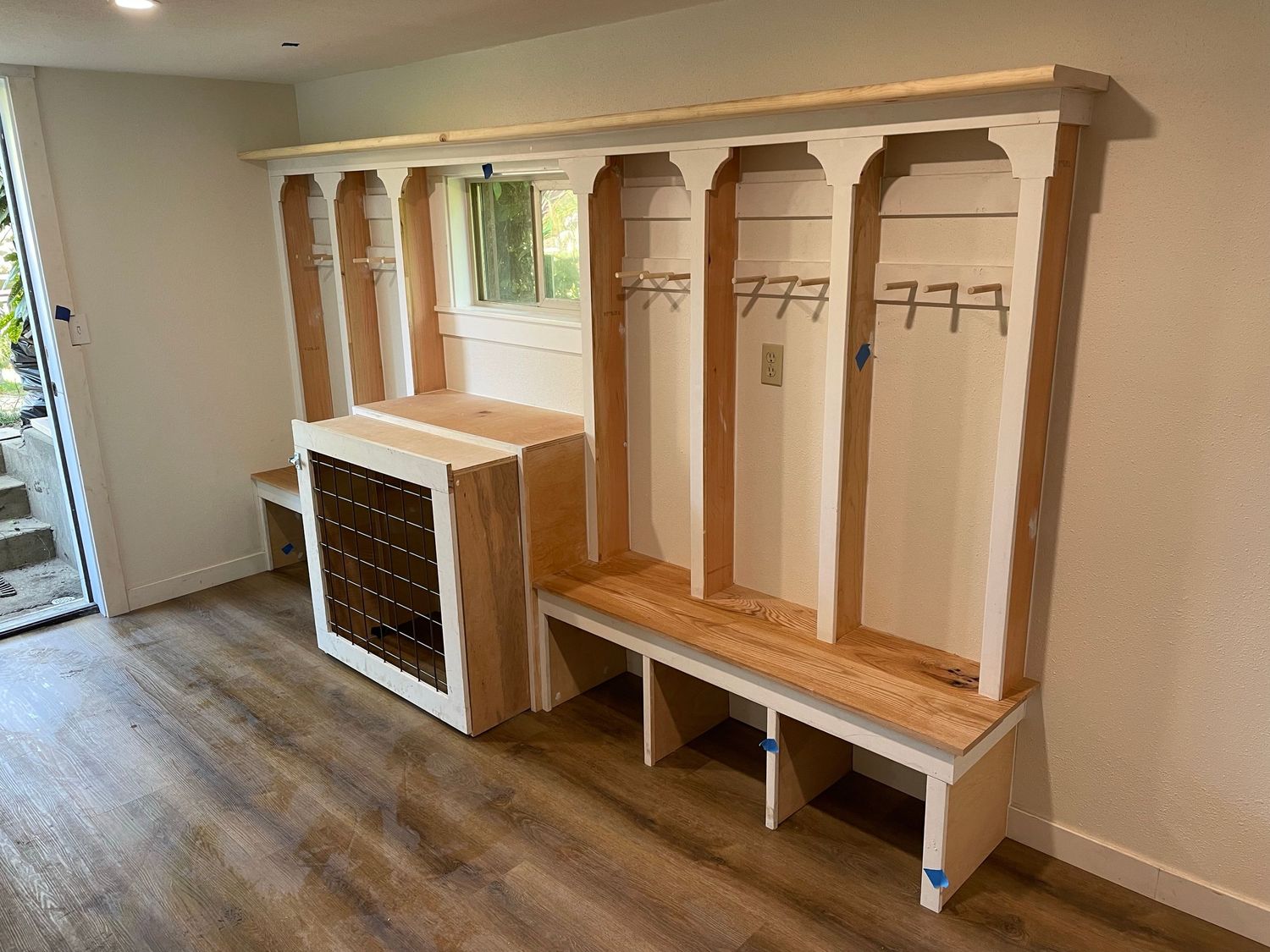This mudroom storage bench includes a retracting dog kennel. (This is before paint.)