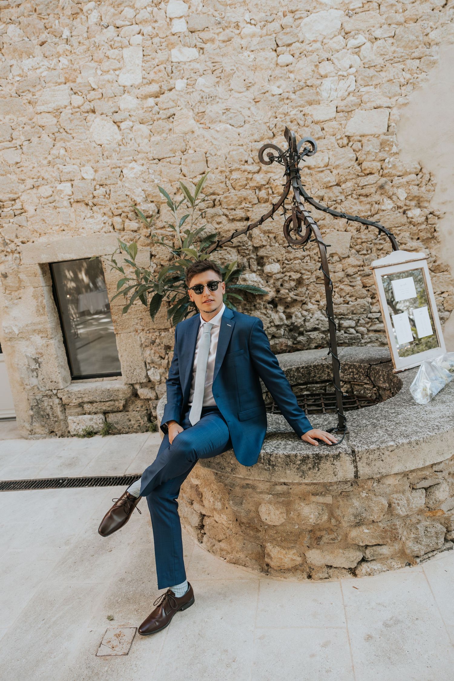 groom posing at Le Petit Roulet wedding in France captured in an editorial documentary style