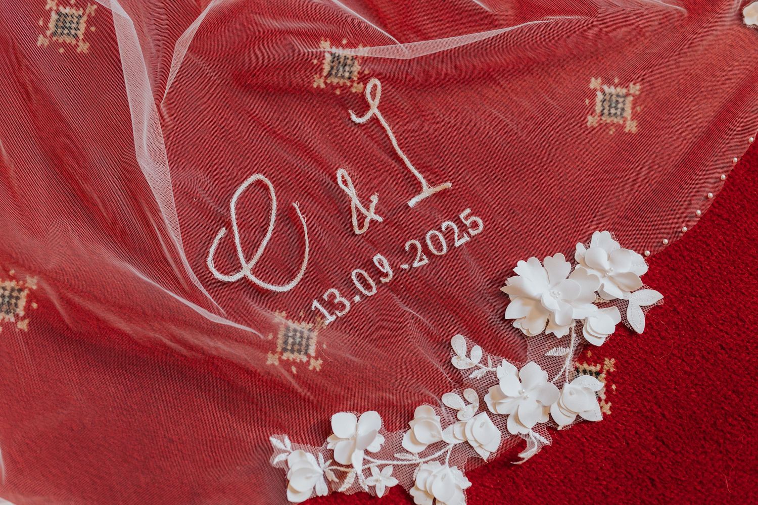 White embroidered wedding veil with initials C & I and date 13.09.2025, adorned with delicate white flowers.