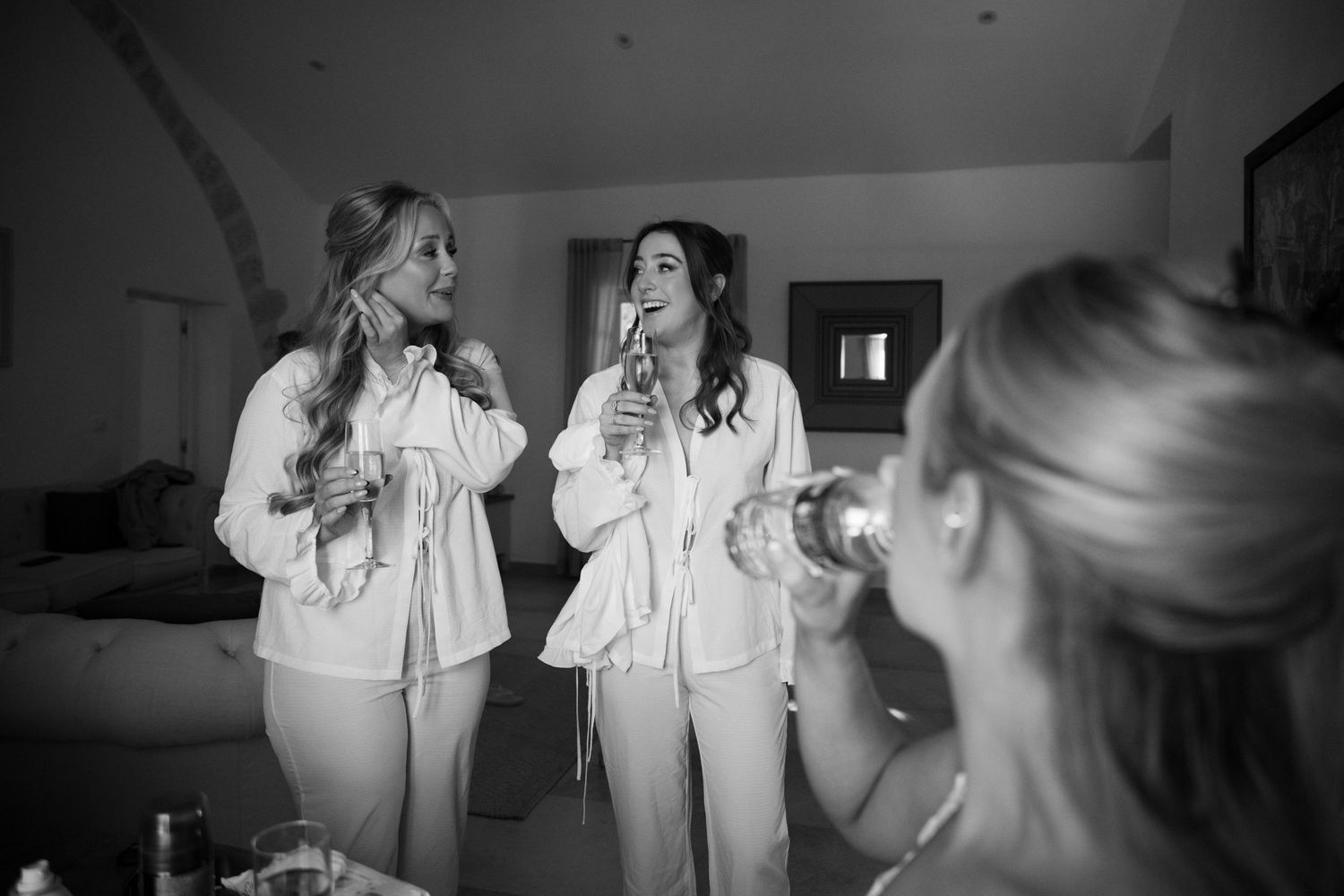 bridesmaids laughing at Le Petit Roulet wedding in France captured in an editorial documentary style