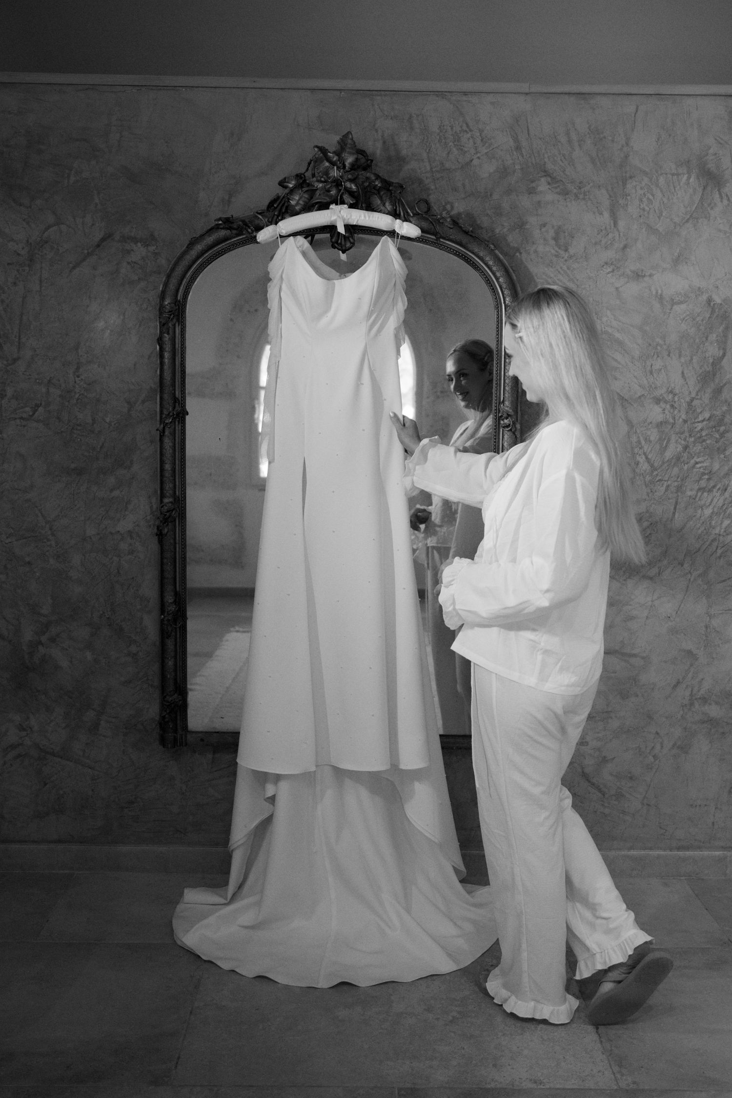 bride touching dress at Le Petit Roulet wedding in France captured in an editorial documentary style