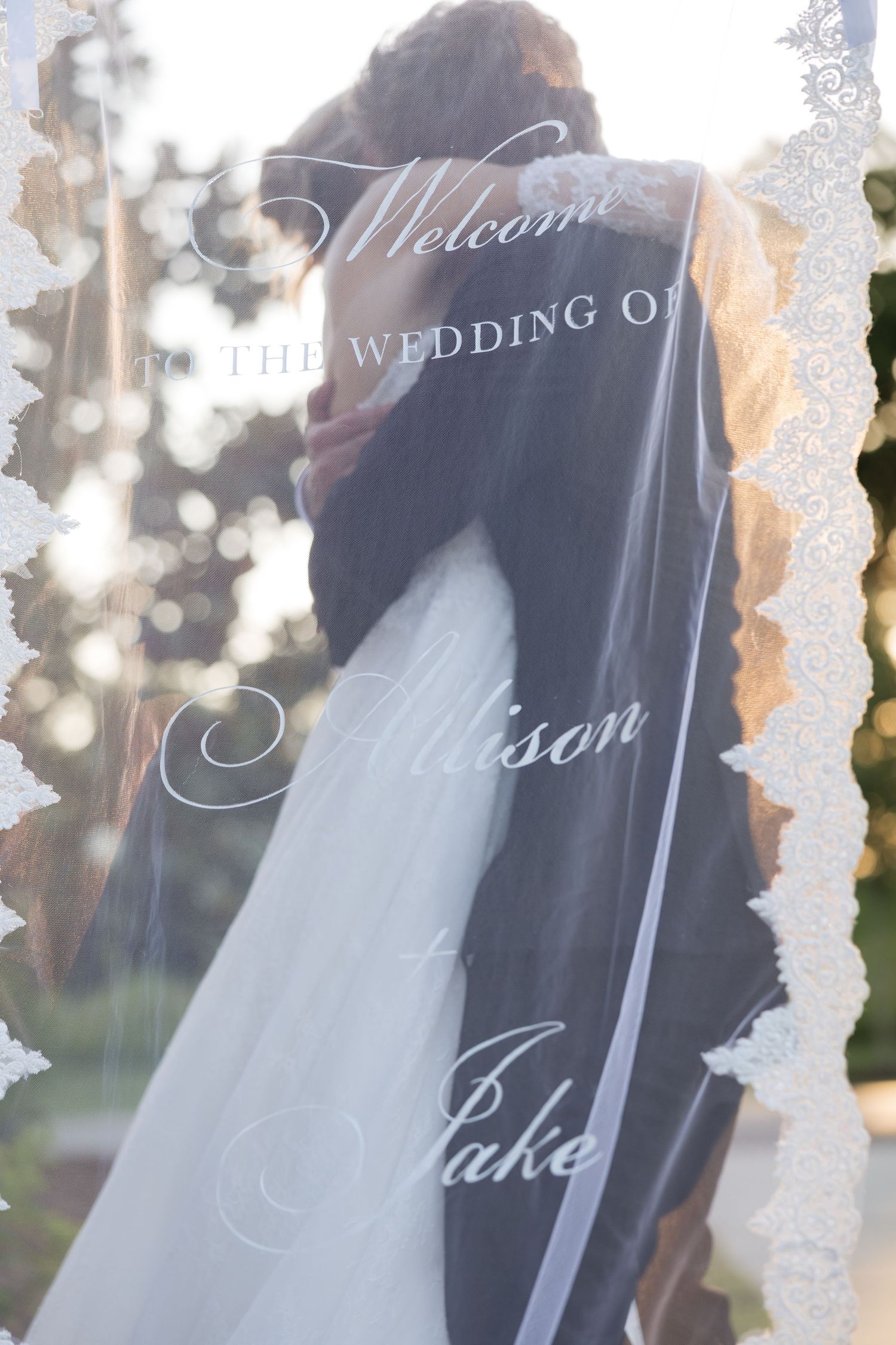 Wedding veil with Welcome to the Wedding of Allison and Jake text overlay.