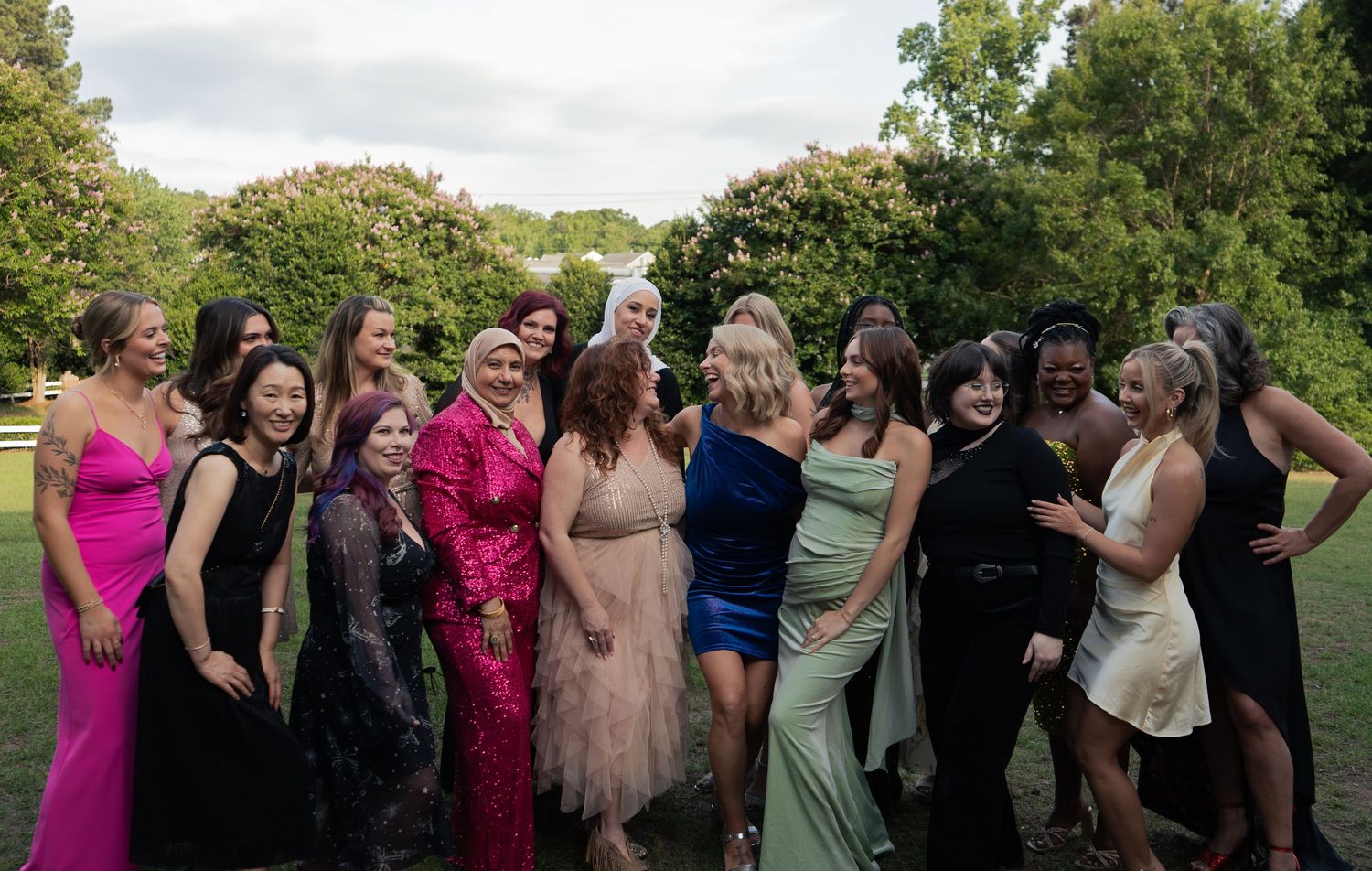 Group of women in elegant colorful formal gowns captured by corporate event photographer in Raleigh