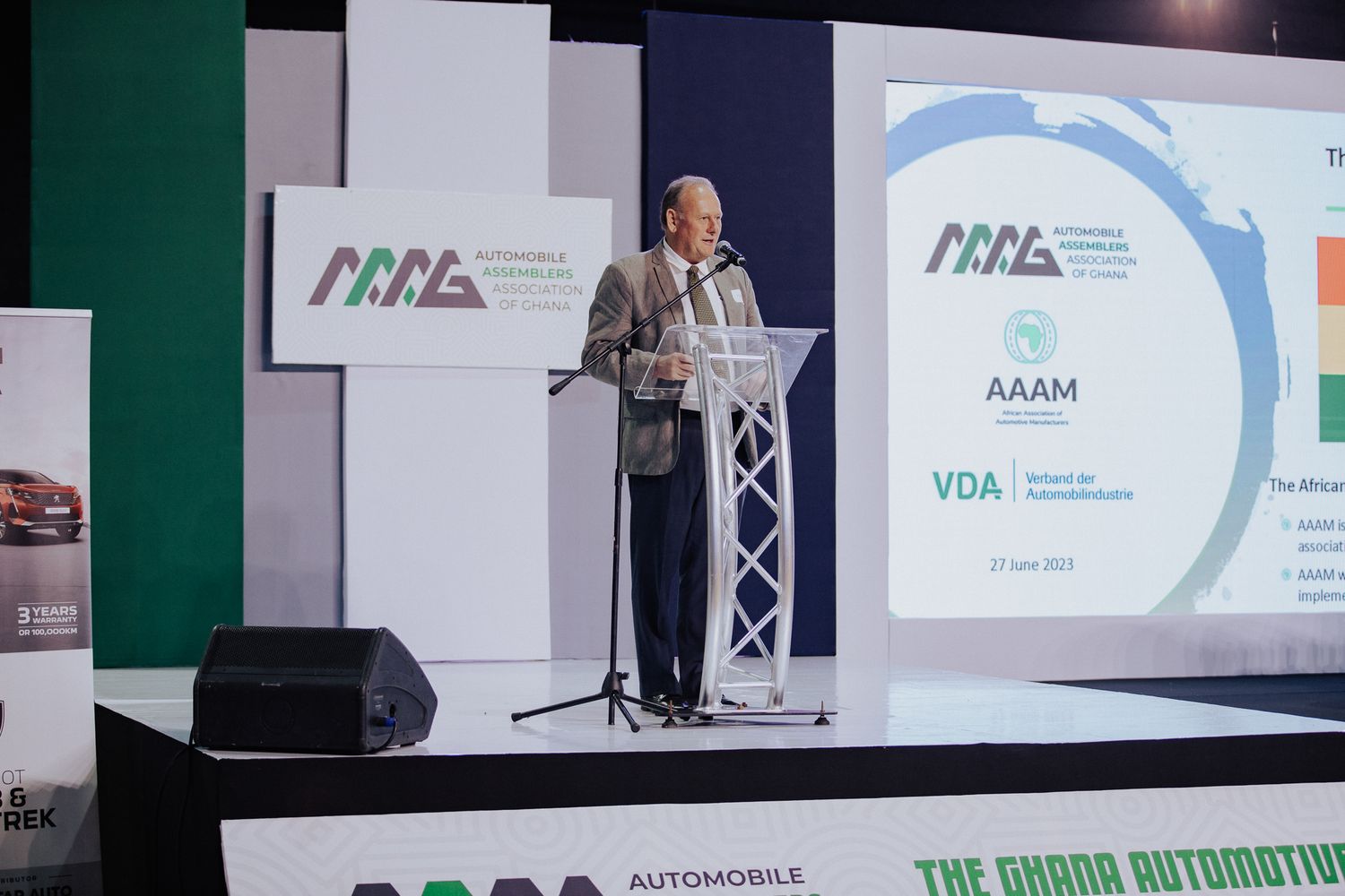 Speaker presenting at Ghana Automotive industry conference with AAAM and VDA branding.