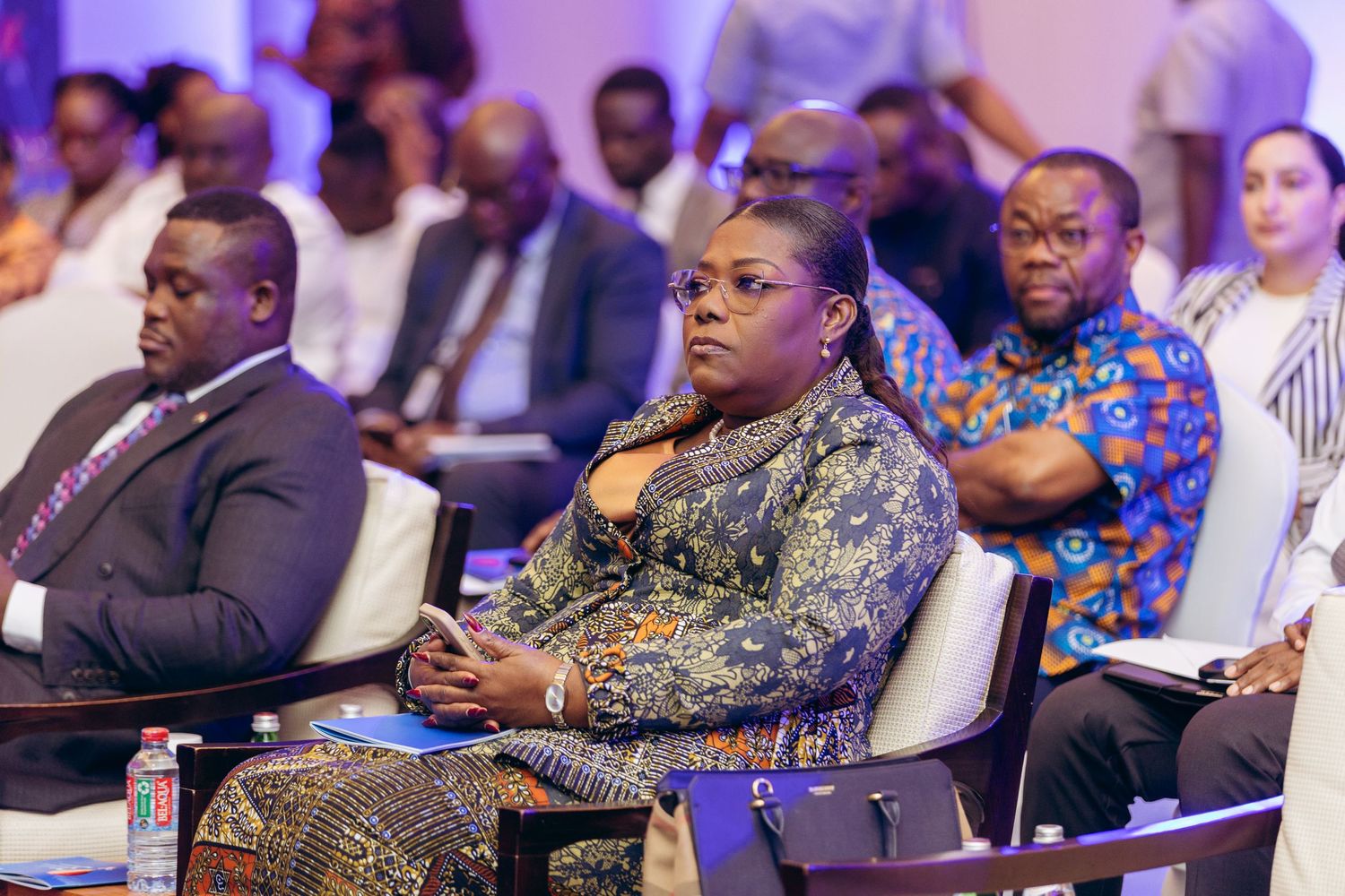 Diverse audience attending professional conference event seated in modern venue.