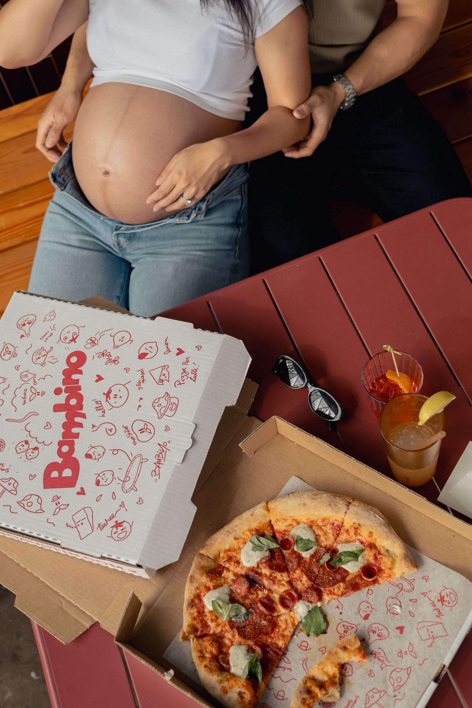 Flat lay of a table with pizza during a lifestyle maternity pizza date session