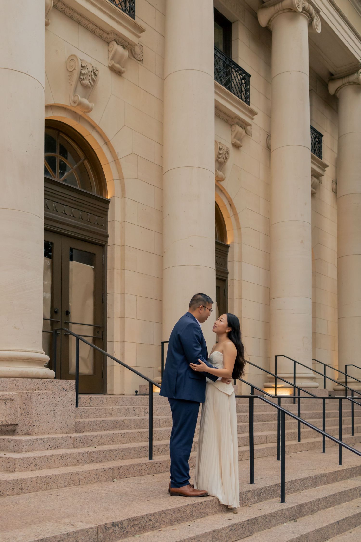 Couple embracing one another in downtown Austin during a sunrise engagement session