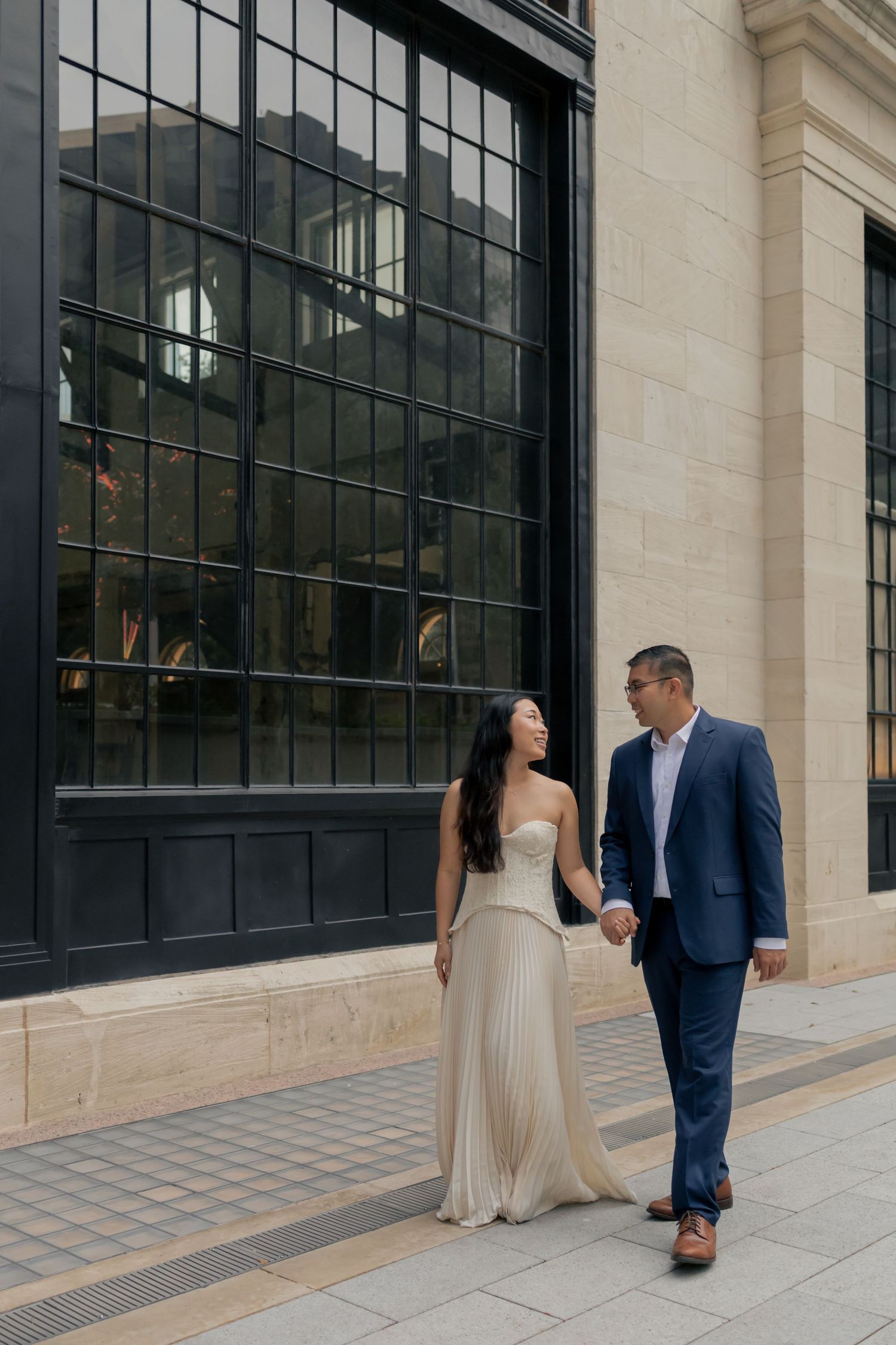 Couple walking and holding hands in downtown Austin during a sunrise engagement session