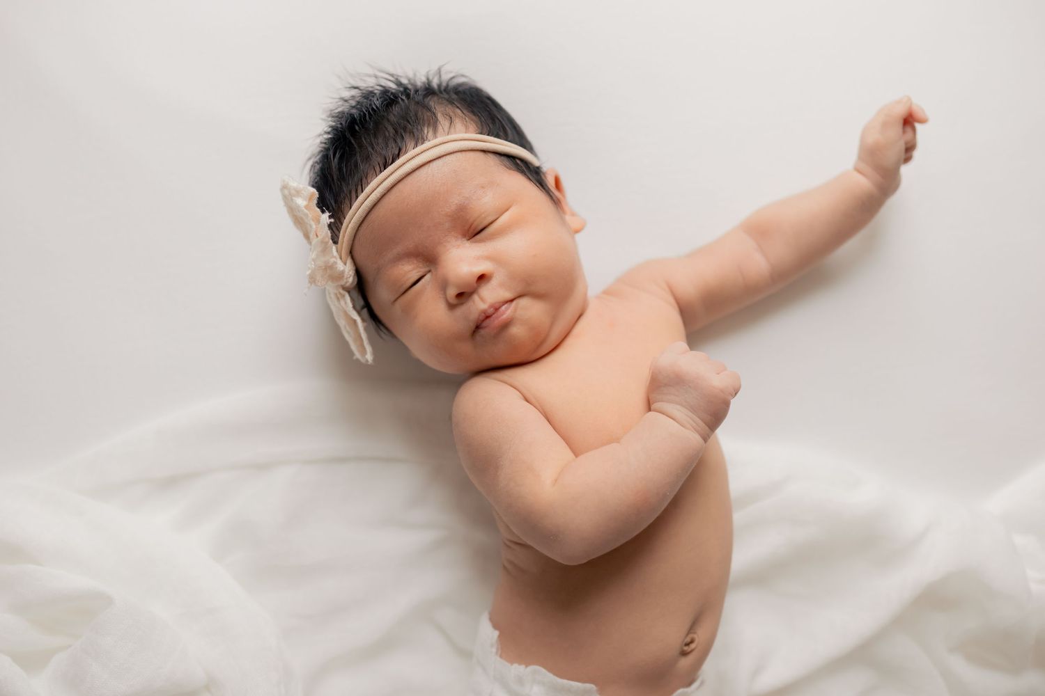 Newborn baby sleeping peacefully during a natural light lifestyle newborn session