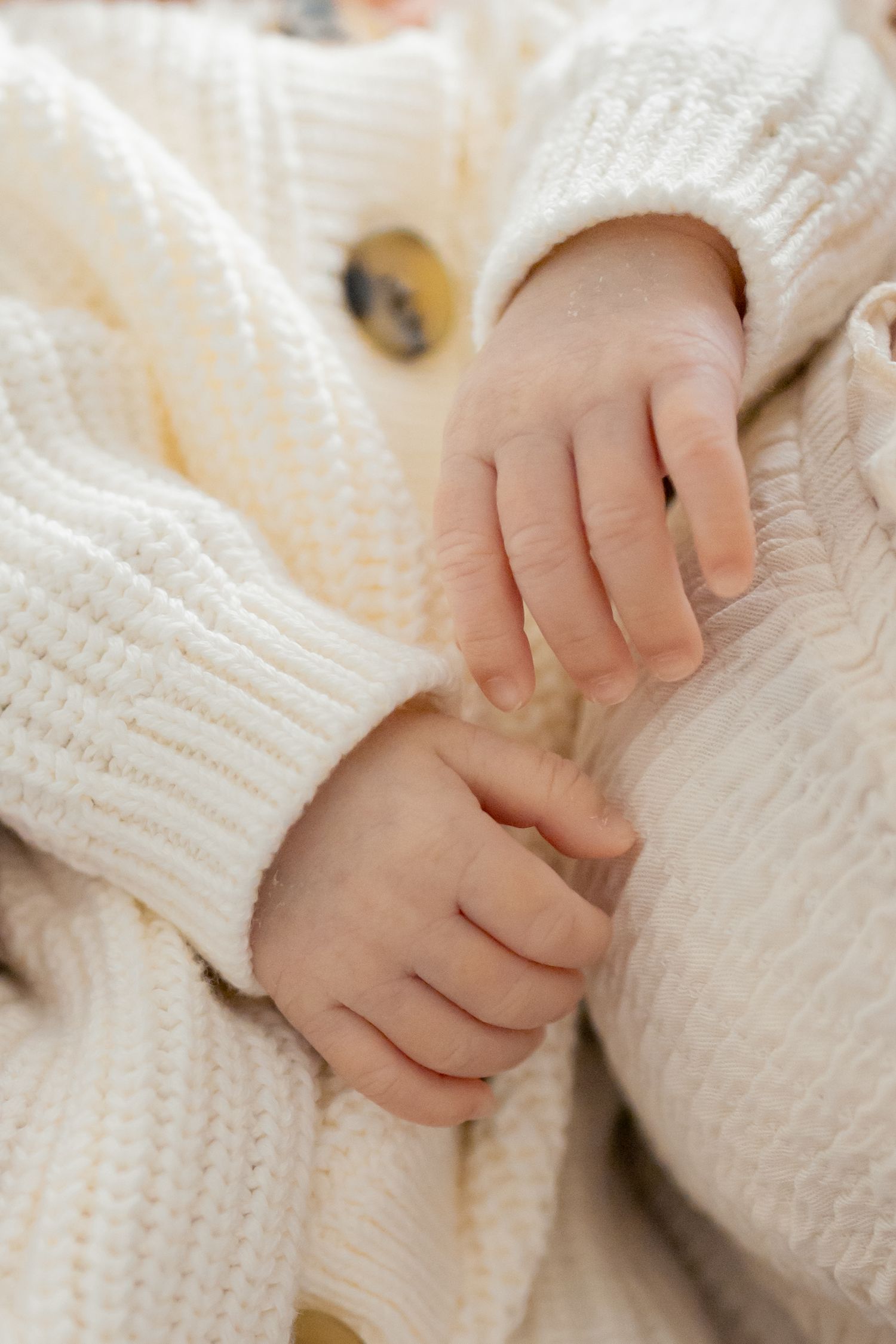 Closeup of newborn baby hands during a natural light lifestyle newborn session