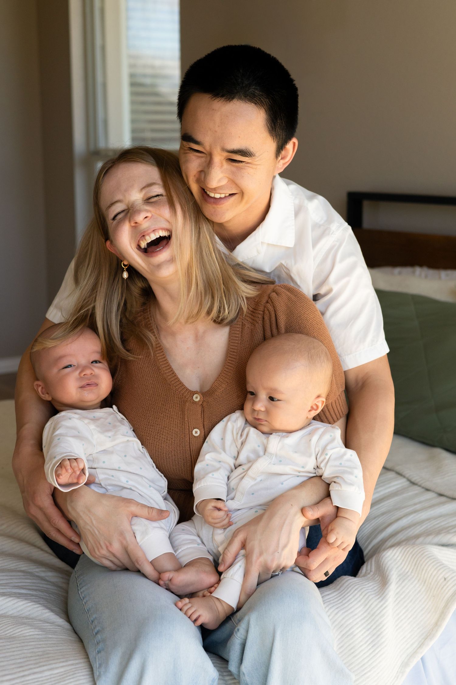 Parents holding their newborn baby twins during a lifestyle newborn session