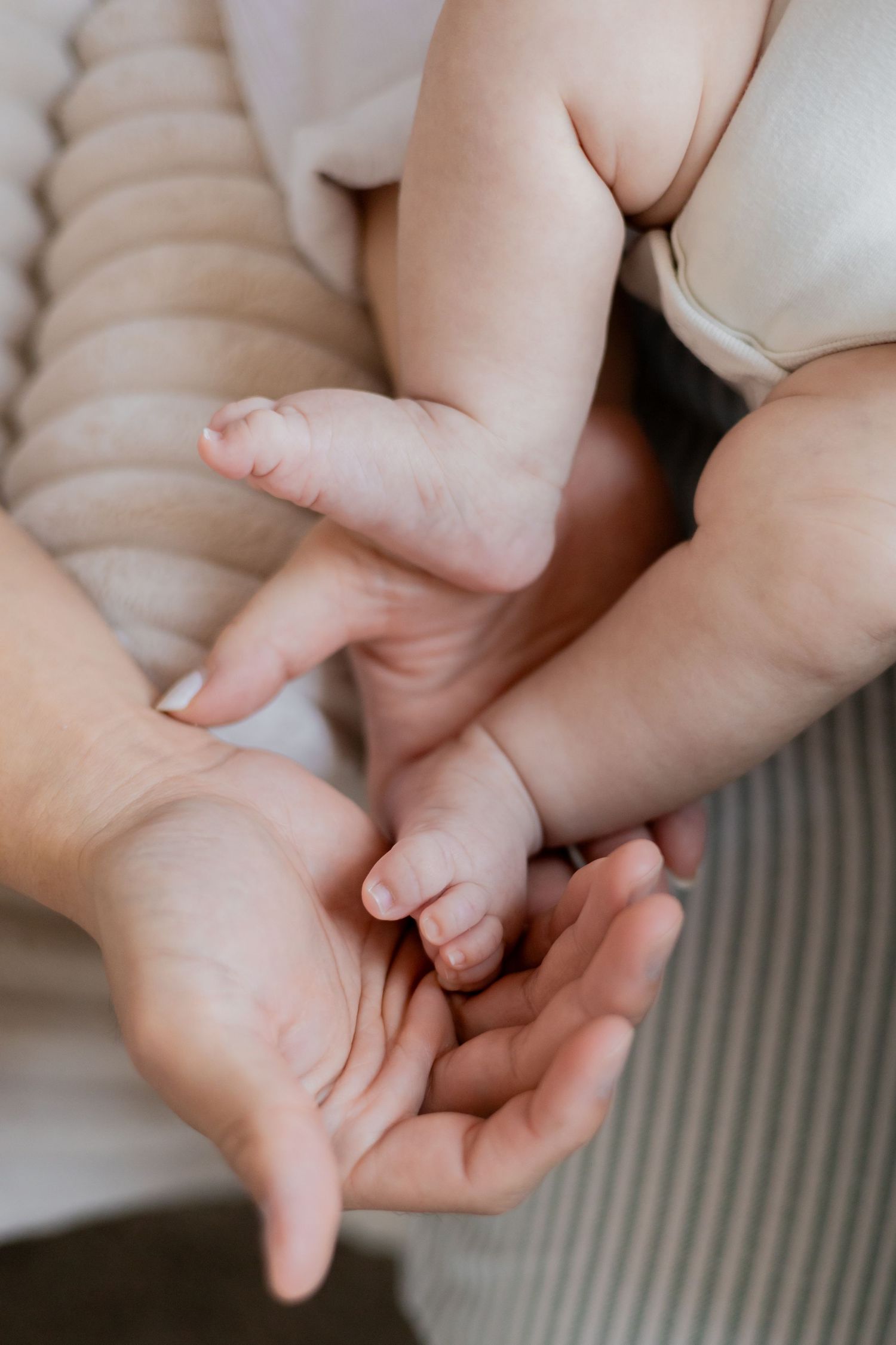 Closeup of dad's hands holding baby feet during a lifestyle newborn session