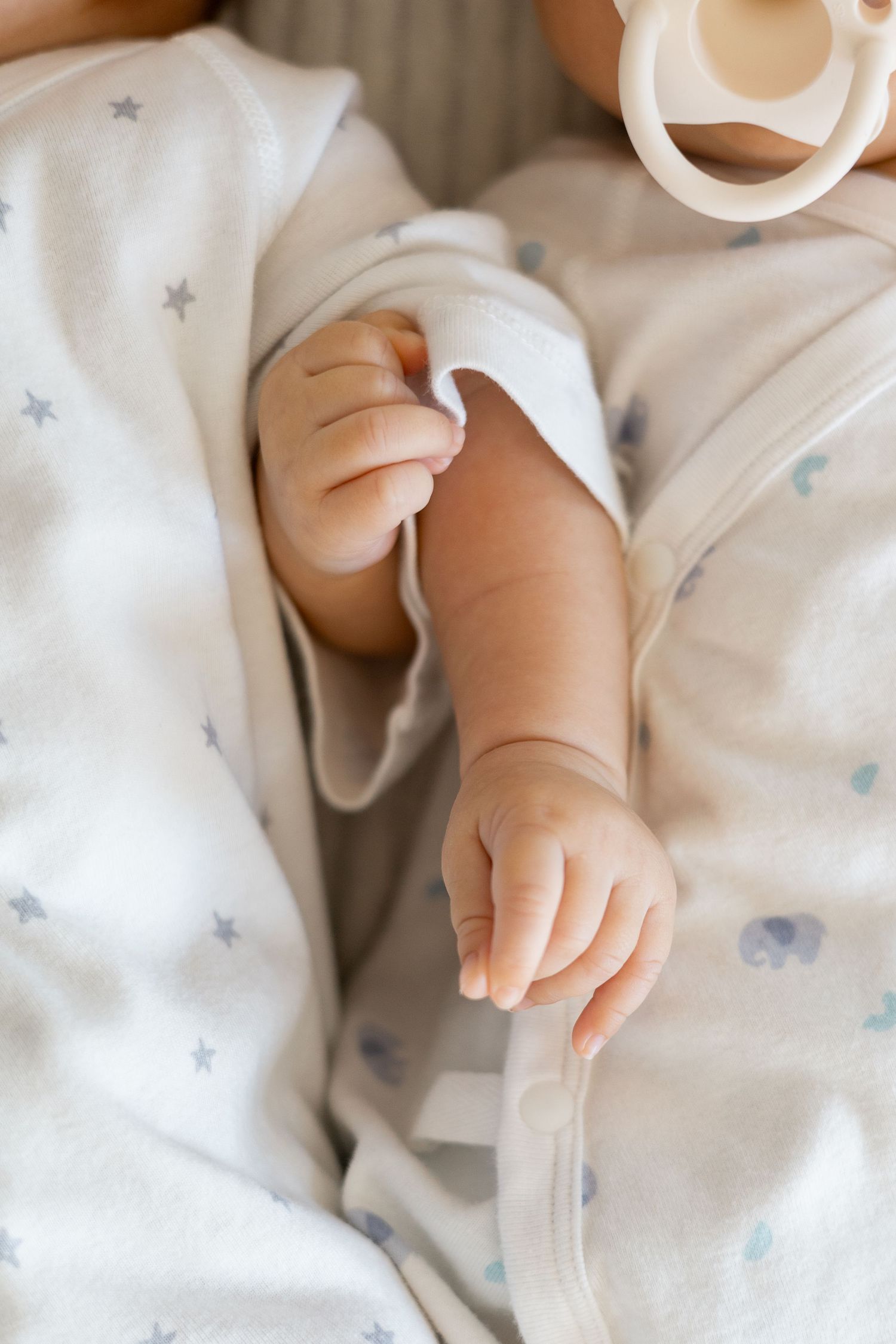 Closeup of newborn twins hands during a natural life newborn baby lifestyle session