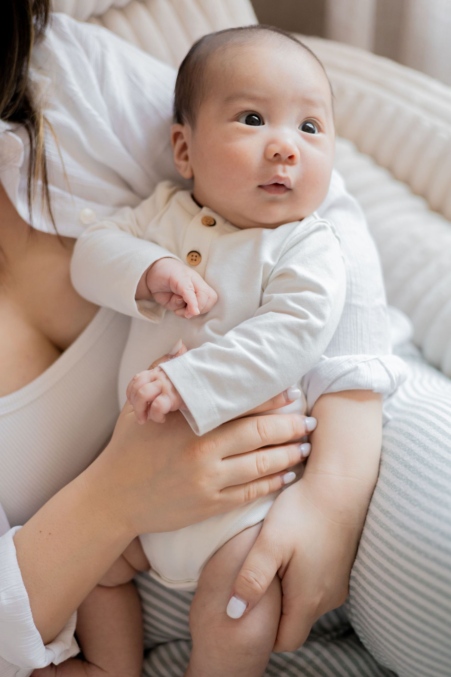 Baby looking up during a natural light newborn lifestyle session