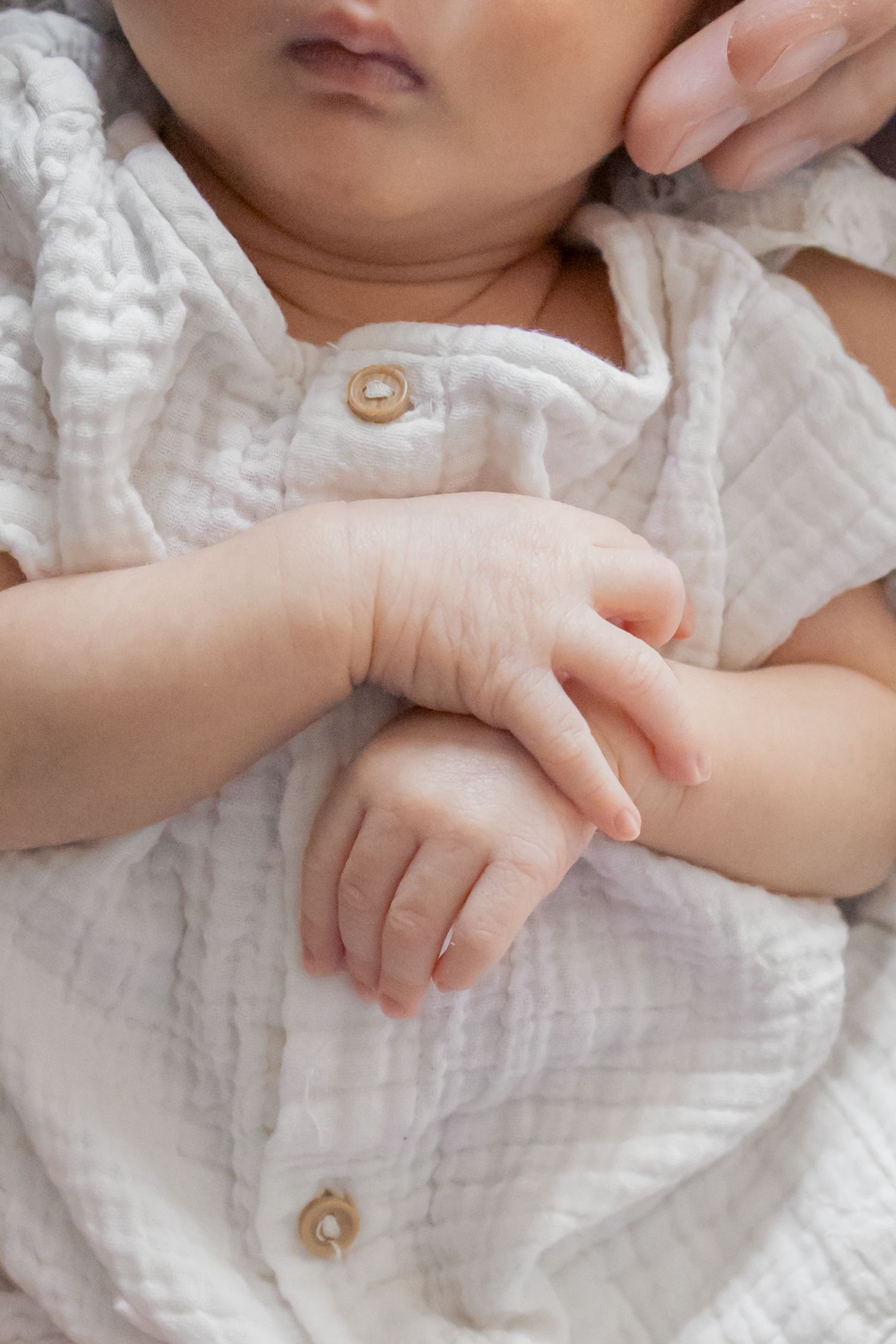 Closeup photo of newborn baby girl hands during a natural light lifestyle newborn session