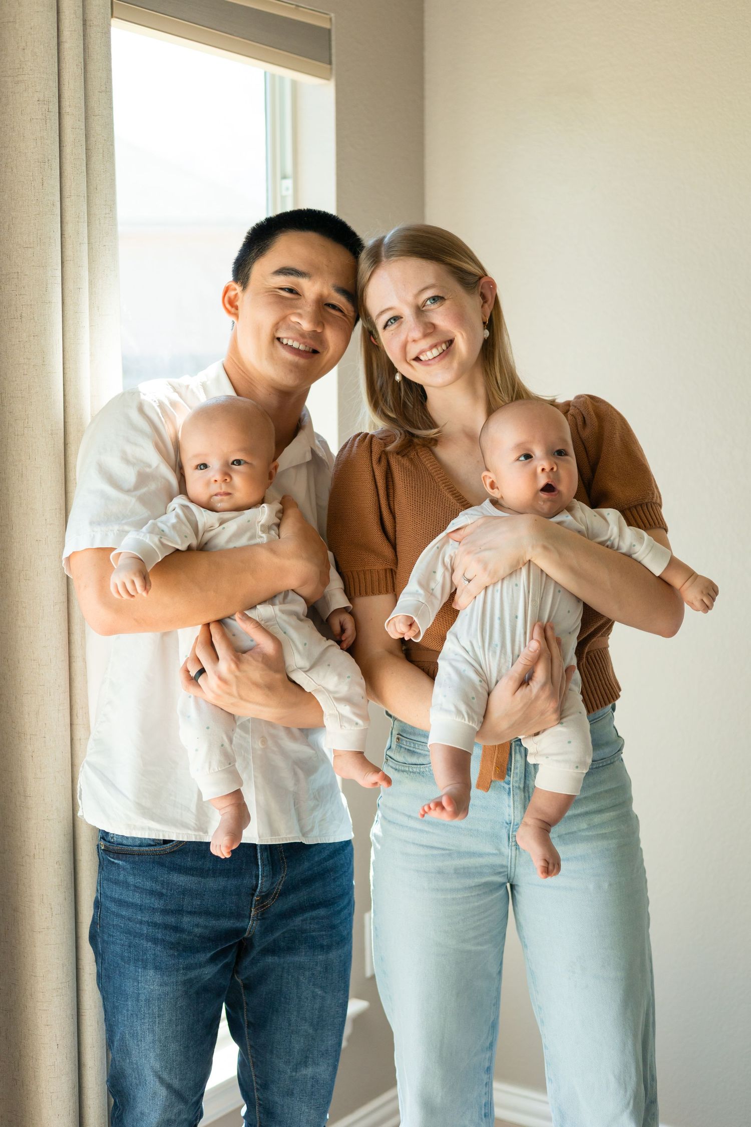 Parents holding their newborn baby twins during a lifestyle newborn session