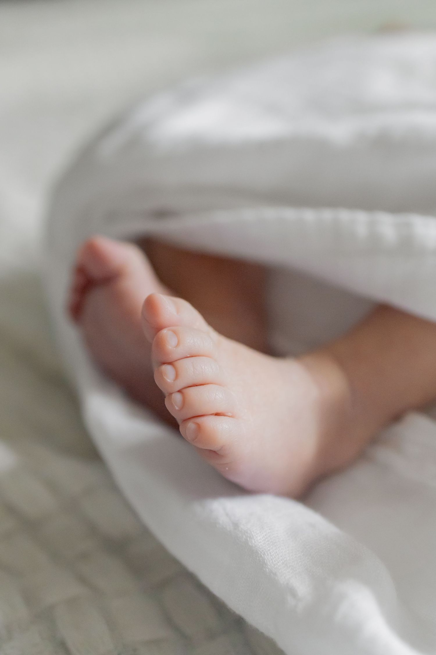 Closeup of newborn baby girl's feet during a natural light lifestyle newborn session