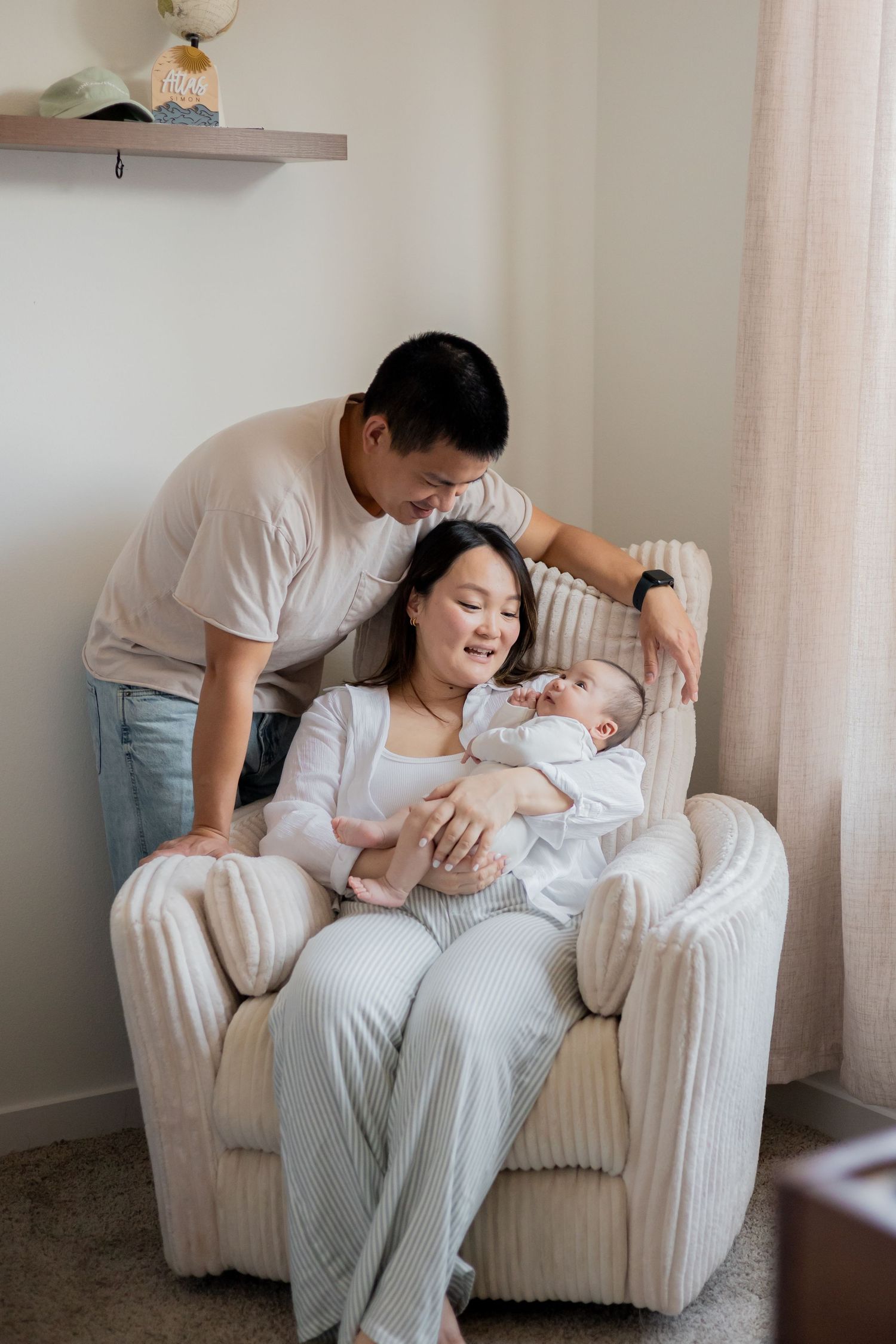 Parents cuddling their firstborn baby during a lifestyle newborn session